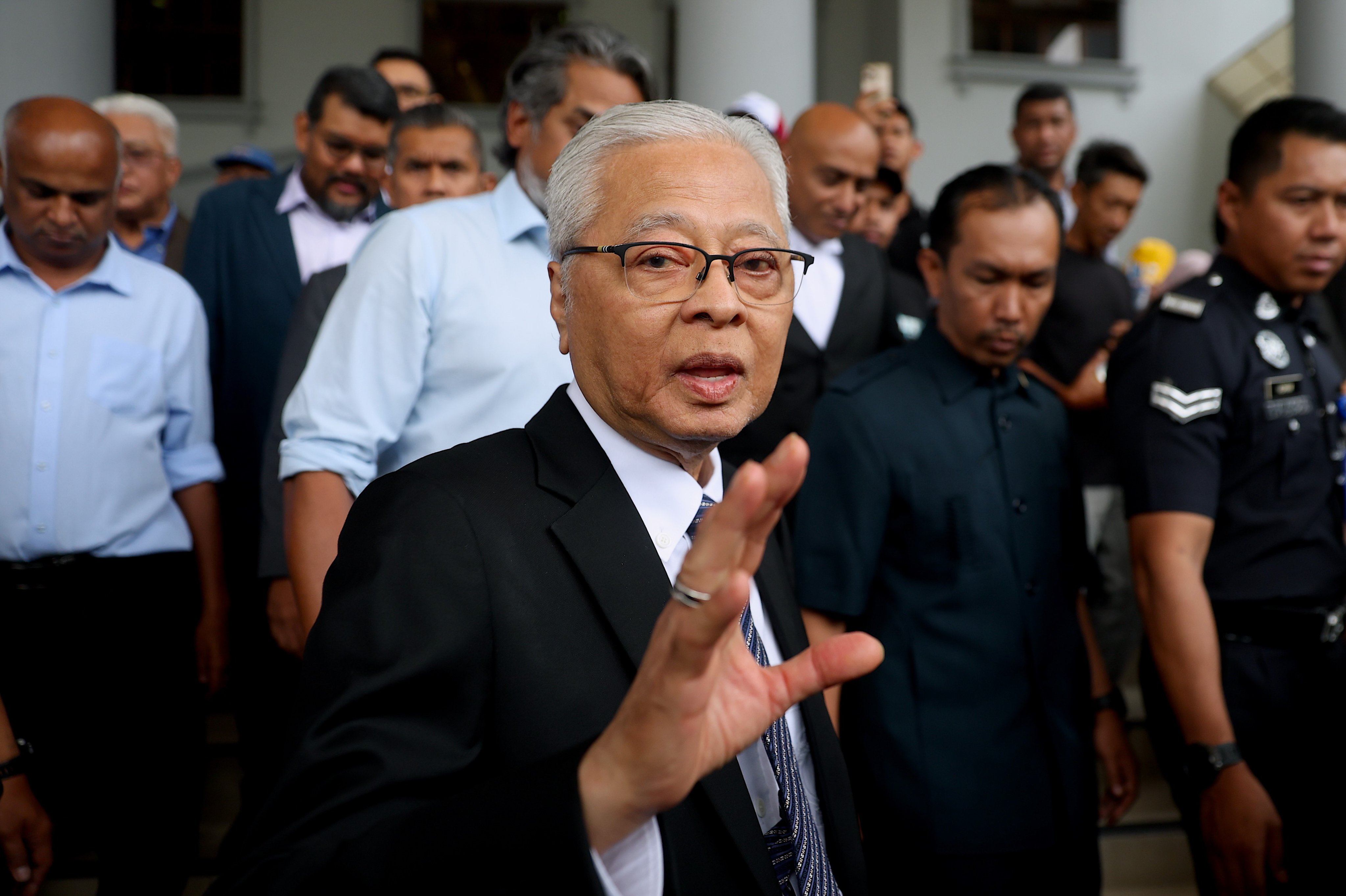 Former Malaysian prime minister, Ismail Sabri, waves as he leaves the Kuala Lumpur court on Thursday. Photo: EPA