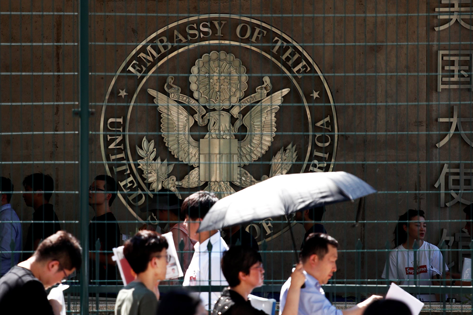 People wait outside the US embassy in Beijing. Photo: Reuters People wait outside the US embassy in Beijing. Photo: Reuters