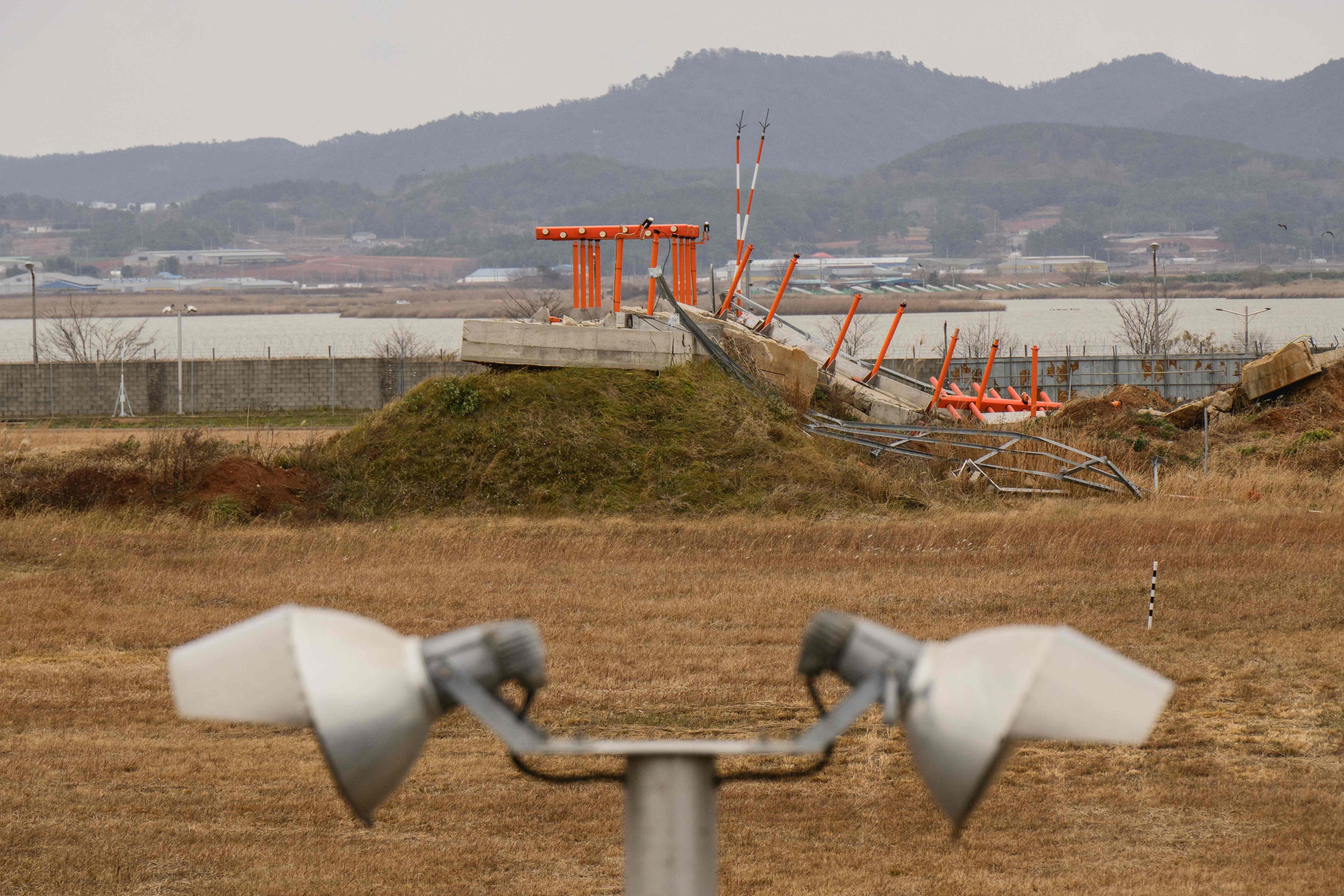 A damaged structure is seen at the end of the runway at Muan International Airport on December 14, 2025, a year after Jeju Air’s Flight 2216 crashed. Photo: AFP
