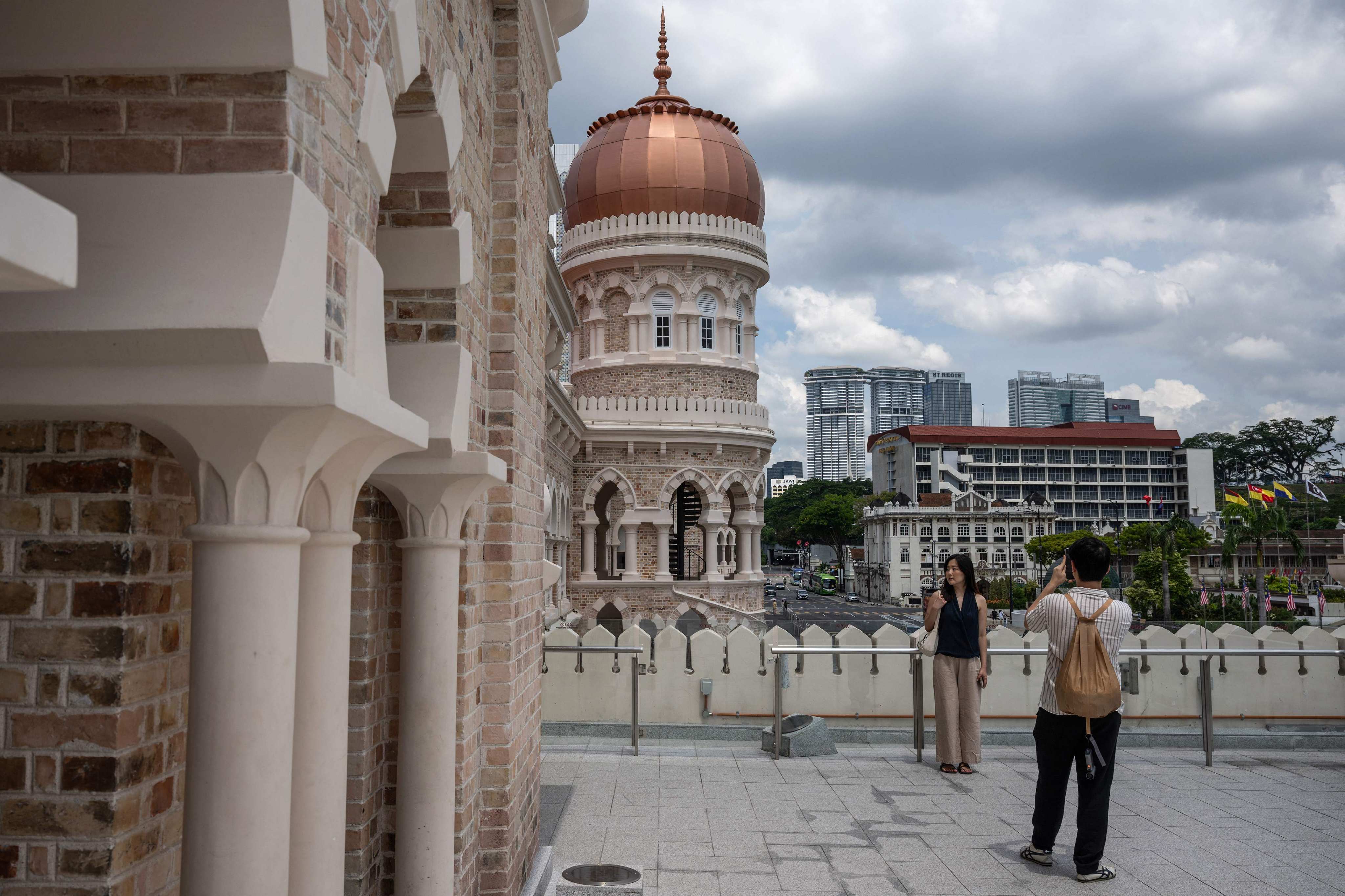 Tourists take pictures with the Sultan Abdul Samad building near Merdeka Square in Kuala Lumpur. Photo: AFP