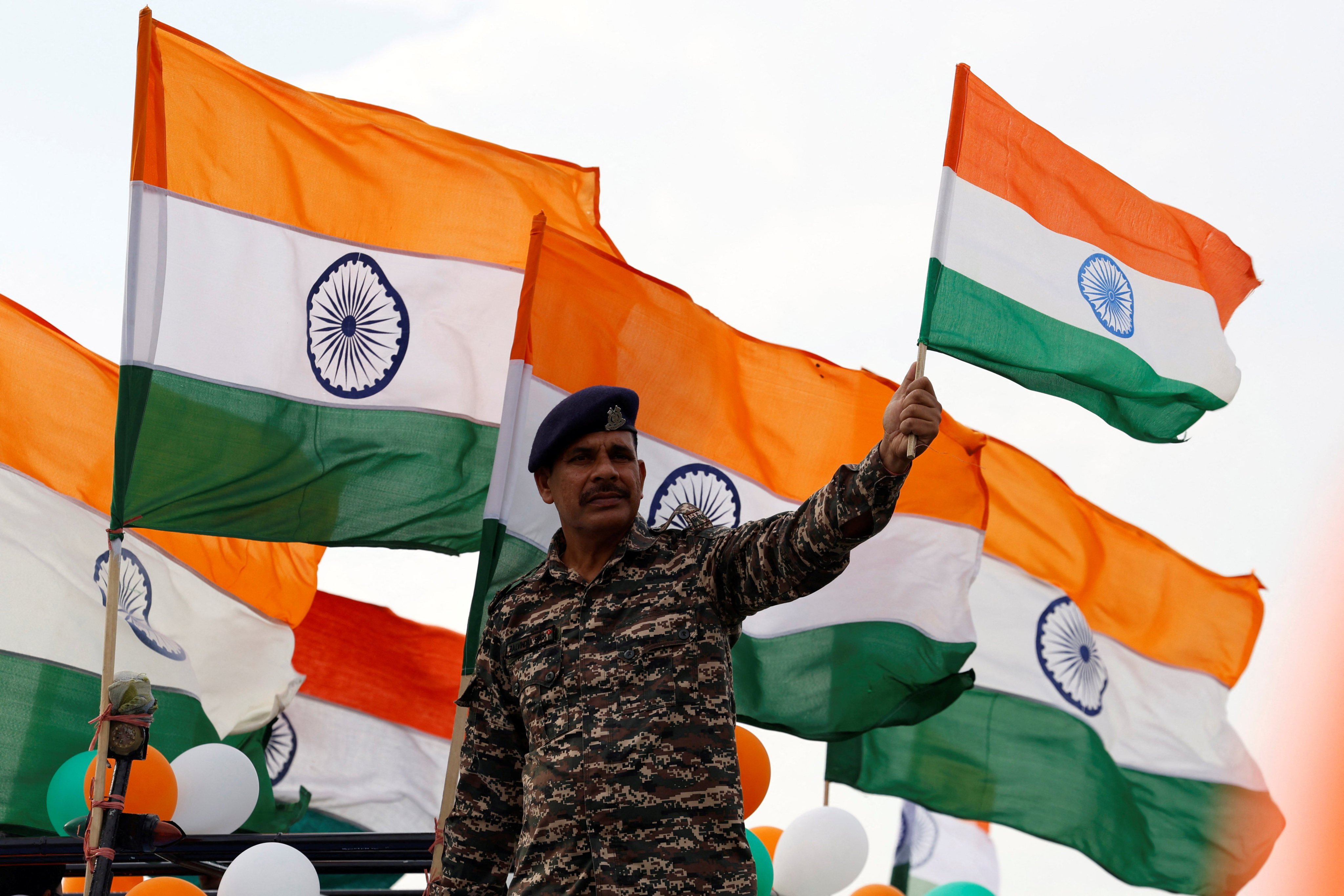 A paramilitary policeman waves India’s national flag in Srinagar, Indian Kashmir, on the eve of Independence Day celebrations this month. Photo: Reuters