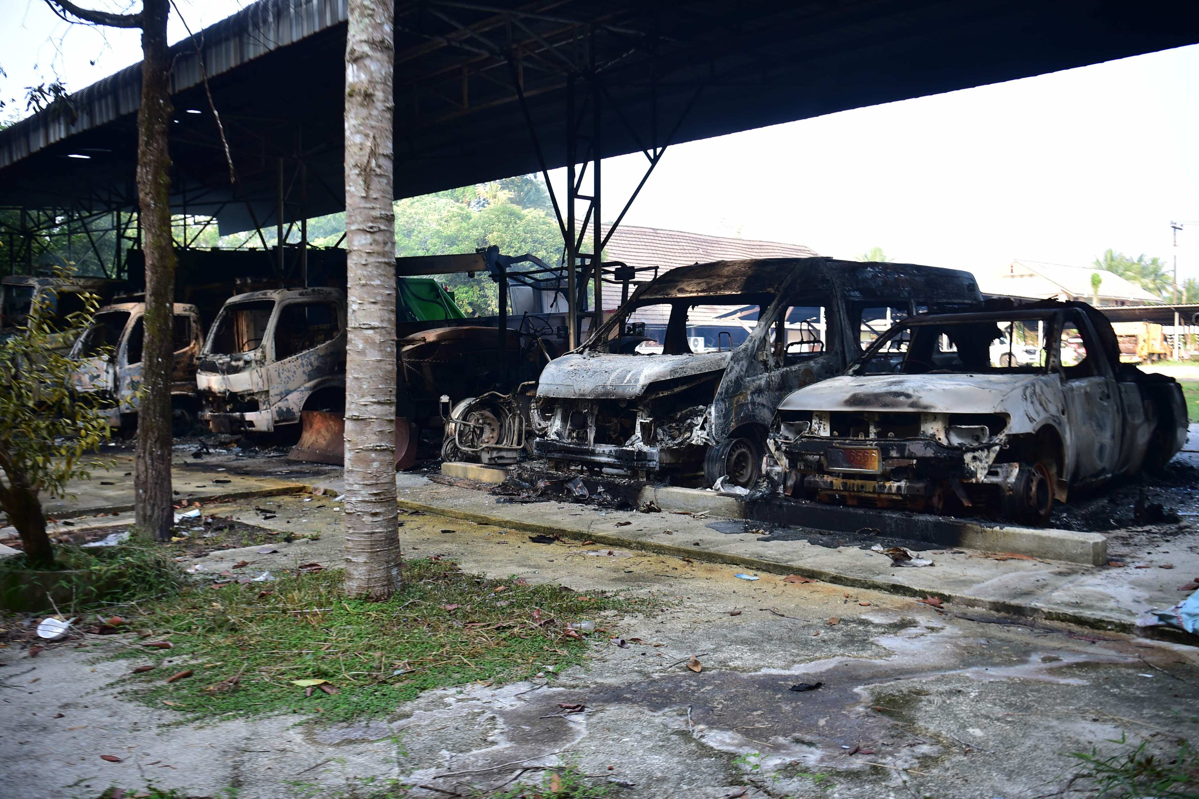 Charred vehicles are seen at an office in the southern Thai province of Narathiwat on Sunday, following dozens of coordinated arson and incendiary attacks across Thailand’s insurgency-hit south. Photo: AFP