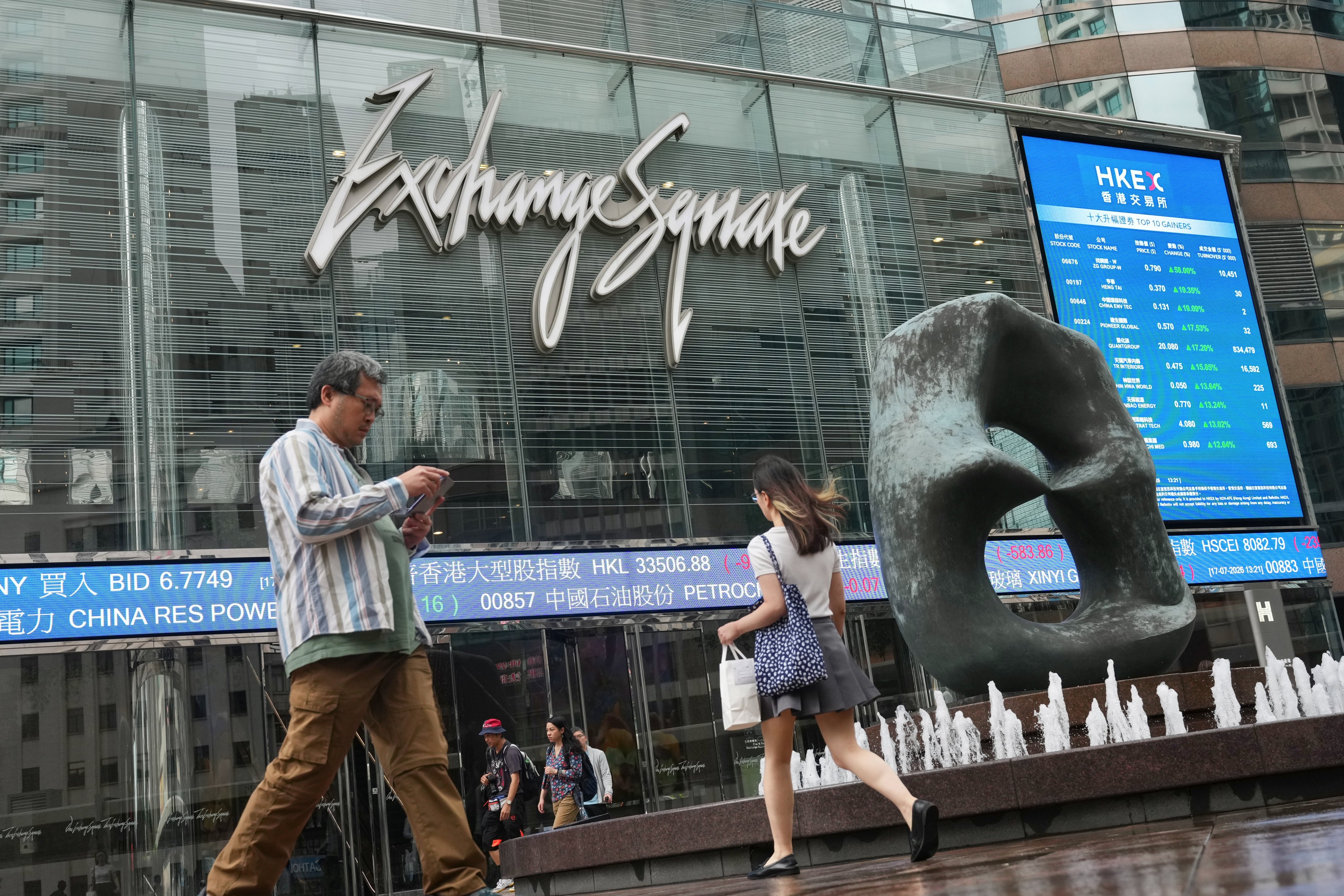 People walk past the Hong Kong Exchanges and Clearing  in Exchange Square, Central, on July 17. Photo: Karma Lo