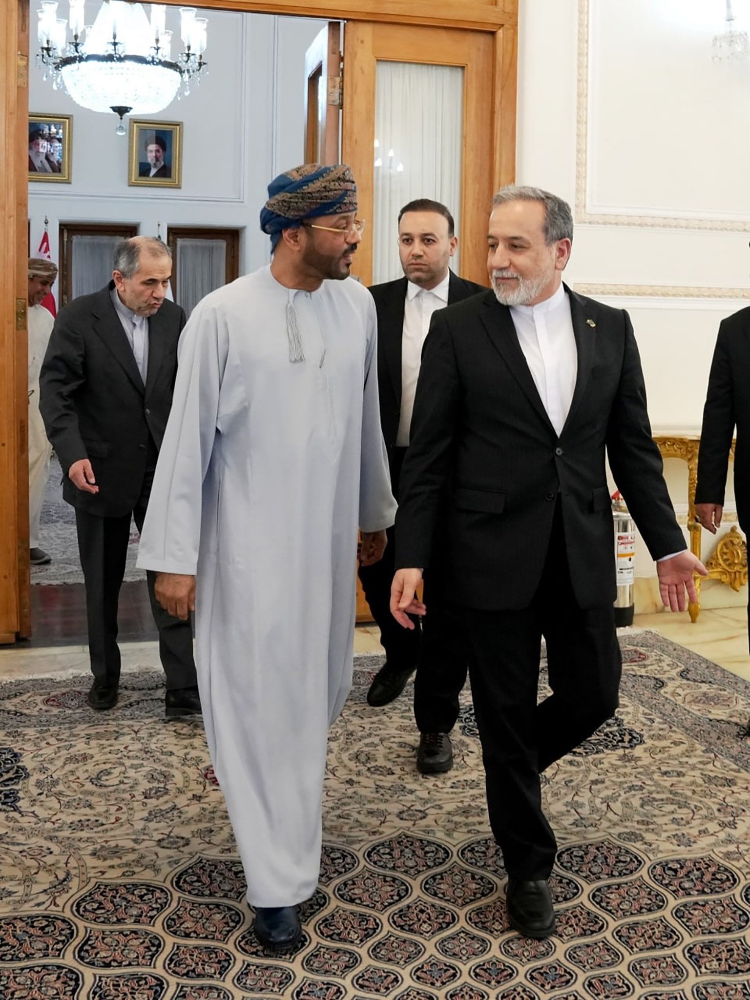 Omani Foreign Minister Sayyid Badr Al Busaidi (centre left) speaks to Iranian Foreign Minister Abbas Araghchi as they walk out of a meeting in Tehran on Tuesday. Photo: Iran’s Ministry of Foreign Affairs/EPA