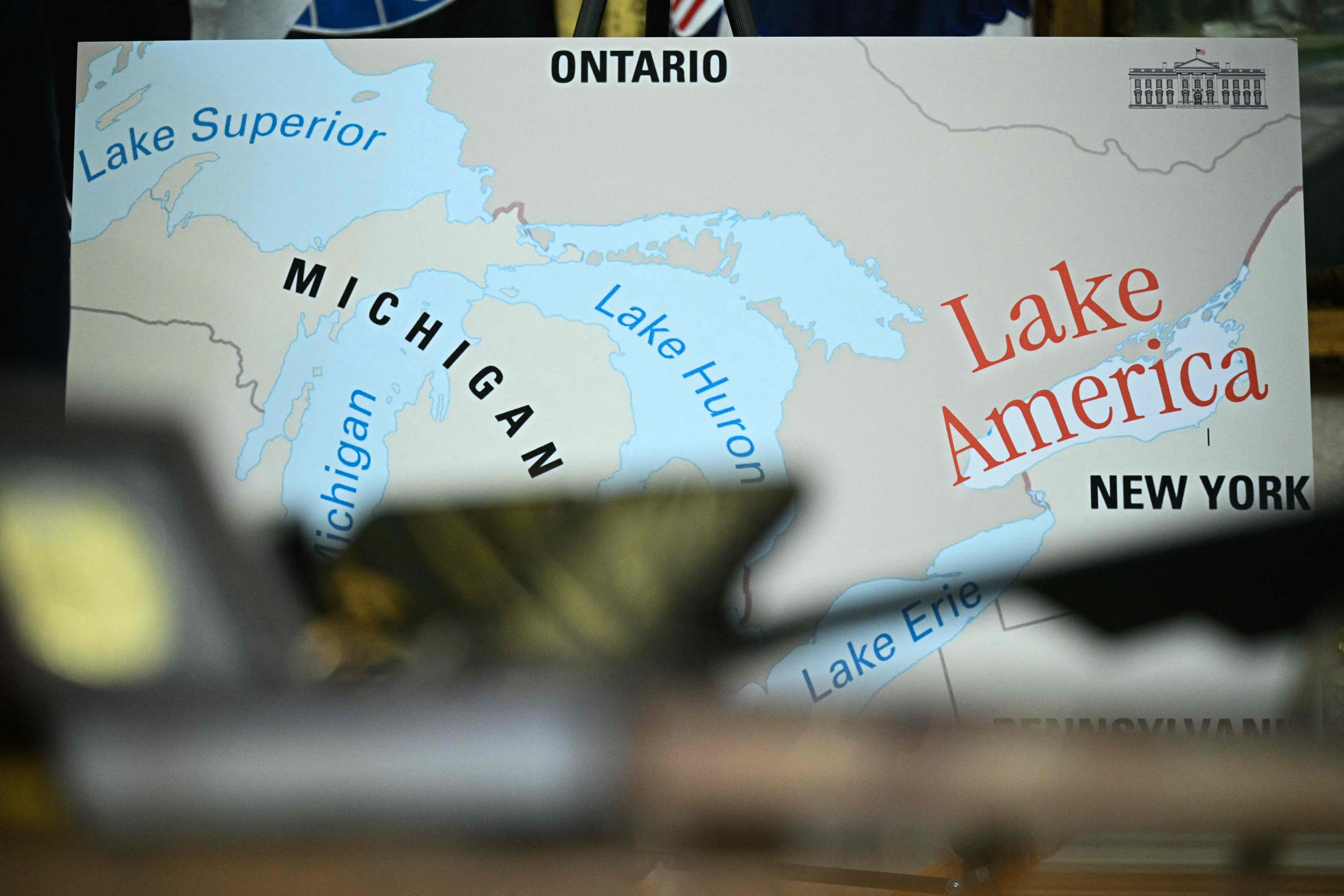 A map is displayed as US President Donald Trump signs an executive order to rename Lake Ontario as Lake America in the Oval Office on Thursday. Photo: AFP