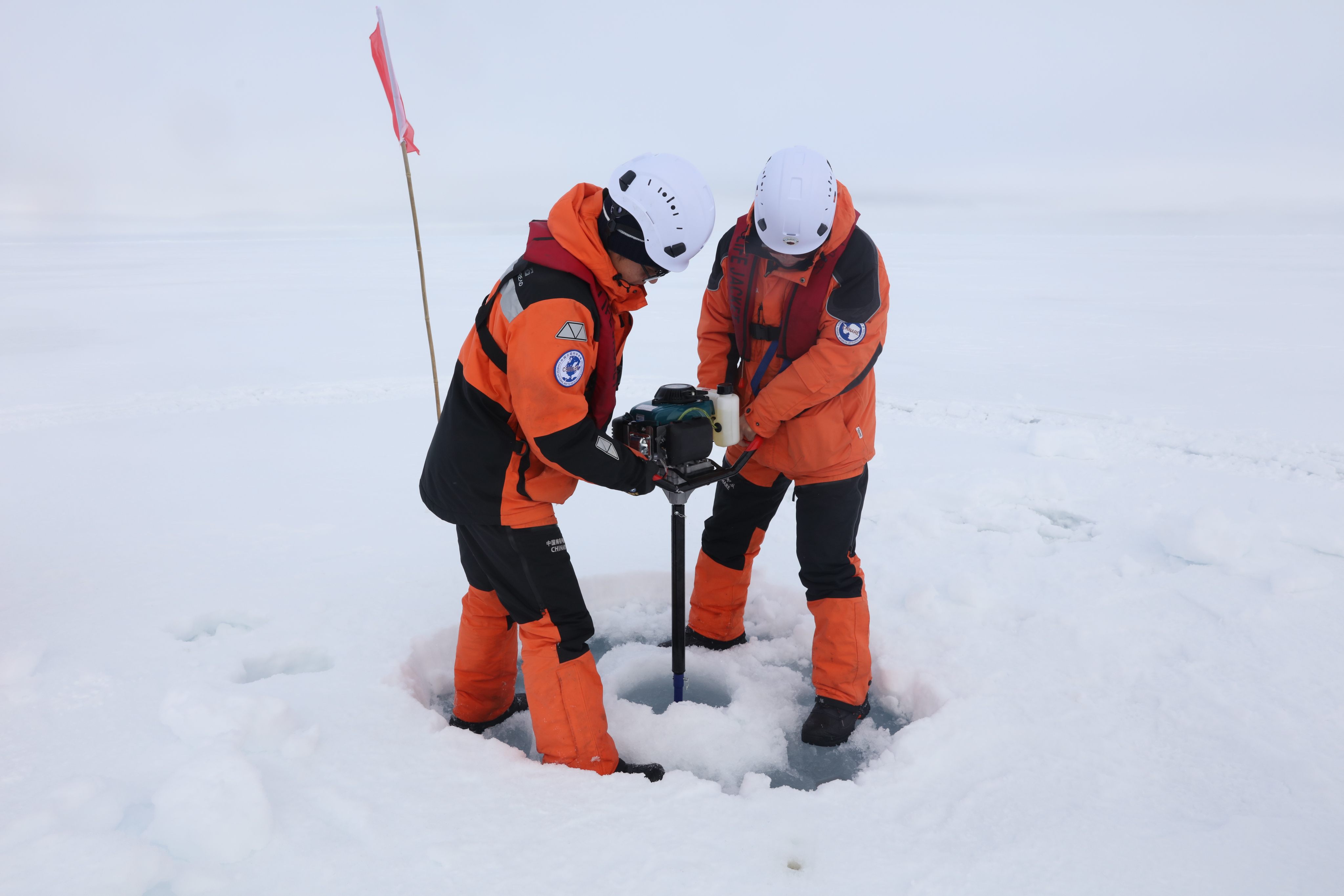 Members of China’s Arctic Ocean scientific expedition team drill through ice on its surface earlier this month. Photo: Xinhua