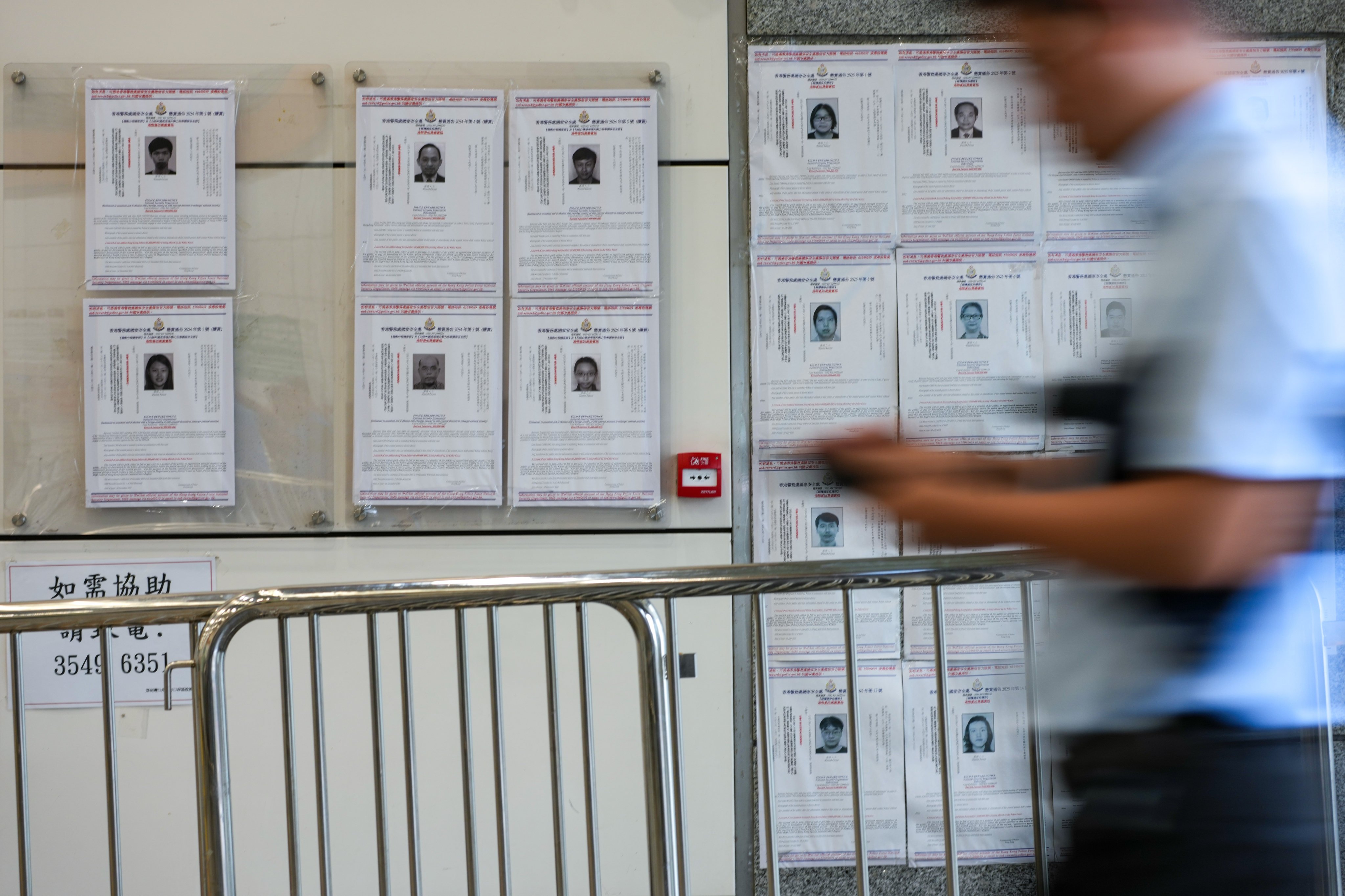 People pass by wanted warrants for overseas activists at Shenzhen Bay border crossing on June 17. Photo: Jelly Tse
