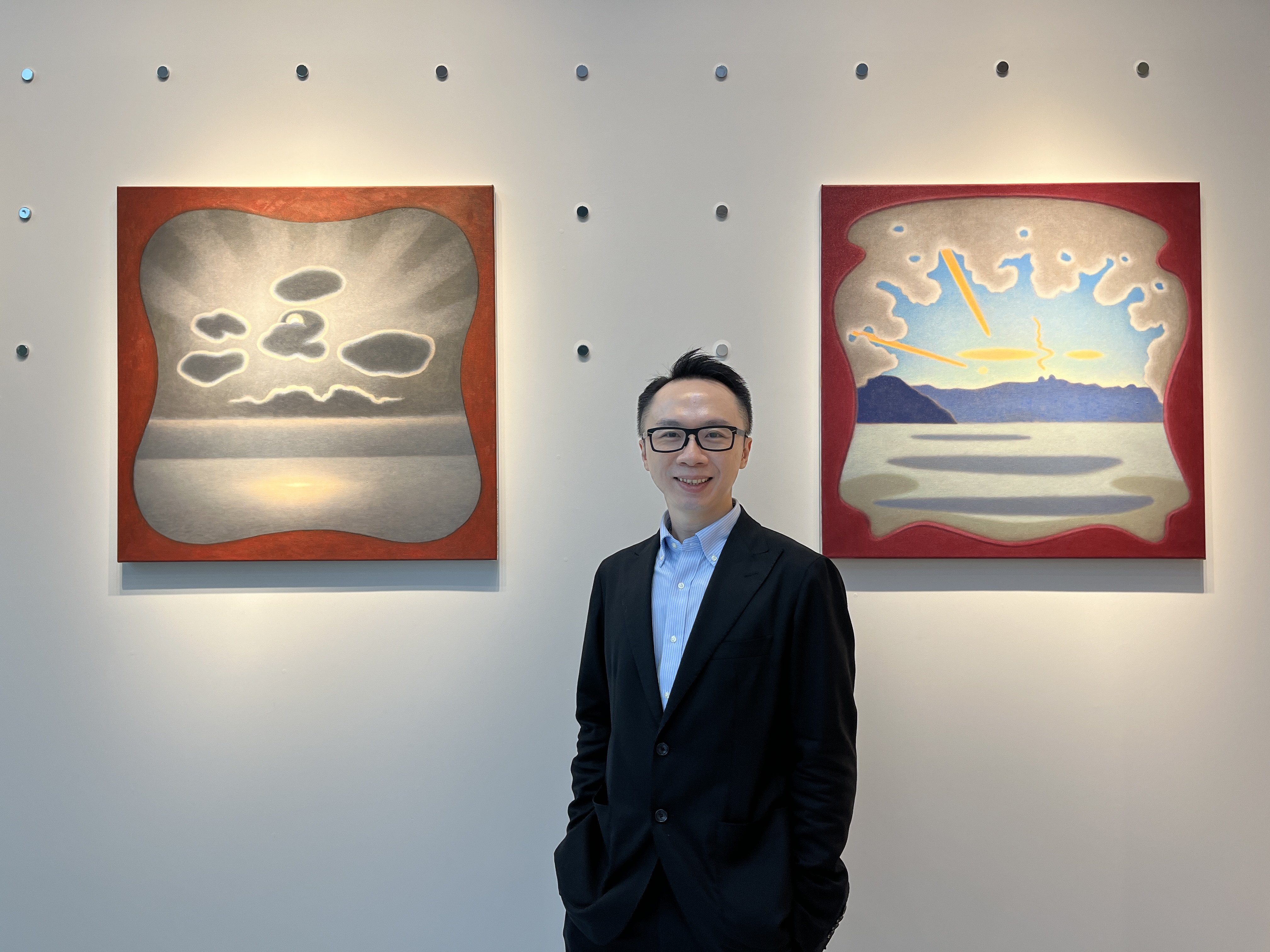 Dr Brian Ip at his Kabinett art space in Wong Chuk Hang, Hong Kong. The artworks are (from left) “Soleil Cache” (2020) and “Nuages Oranges et Gris” (2022) by Caroline Bachmann. Photo: Enid Tsui