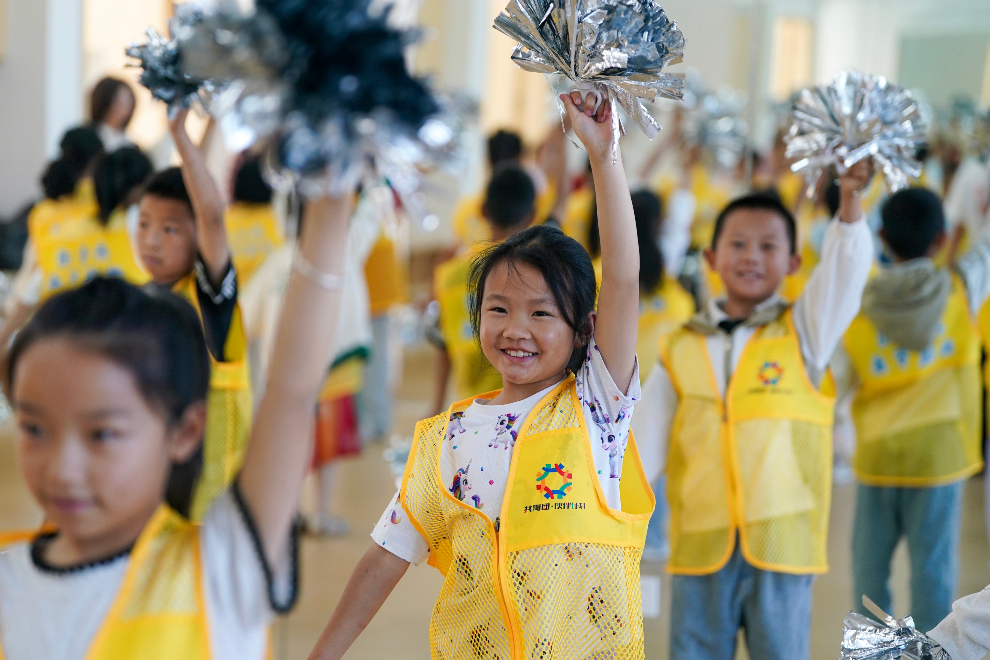 Children enrolled in a daycare programme learn a cheer routine at an activity centre in Zhaotong city, Yunnan province, earlier this month. Zhaotong has introduced free daycare for working parents needing workday childcare coverage. Under the plan, children are assisted with homework and participate in extracurricular activities. Photo: Xinhua
