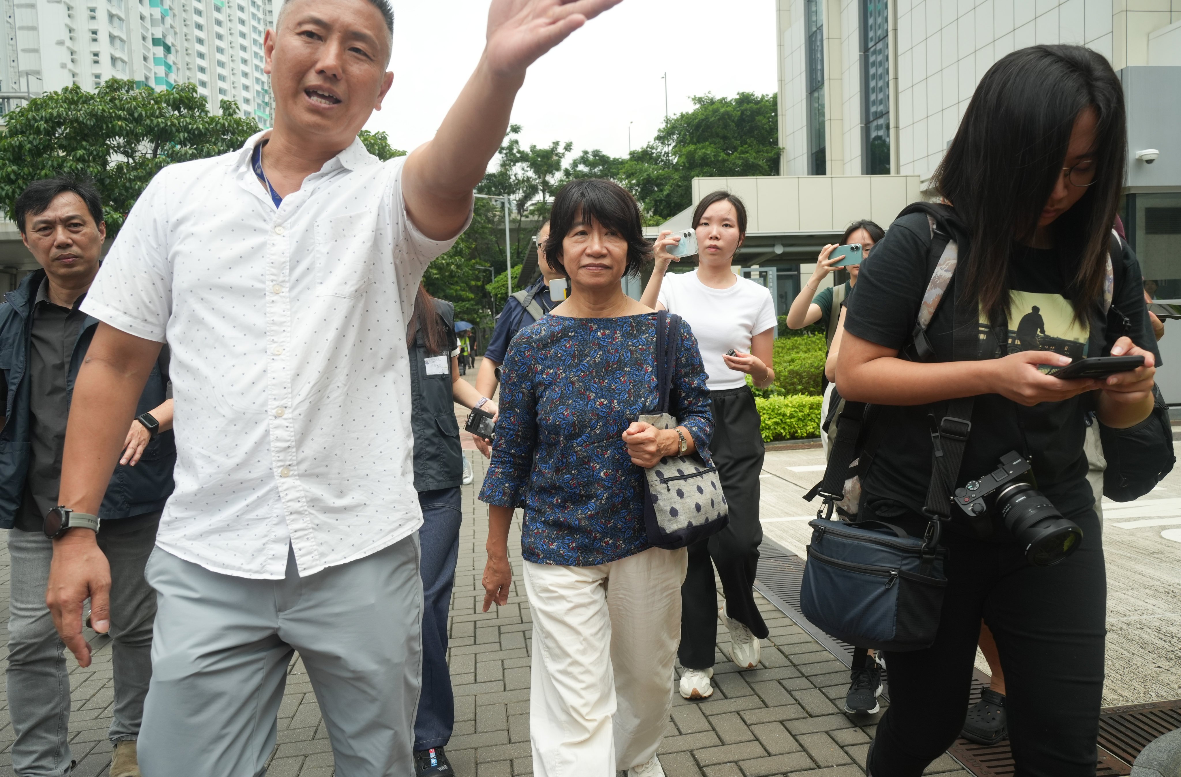 Lee Cheuk-yan’s wife, Elizabeth Tang (centre), leaves the court building after the defence submitted oral mitigation. Photo: Sun Yeung