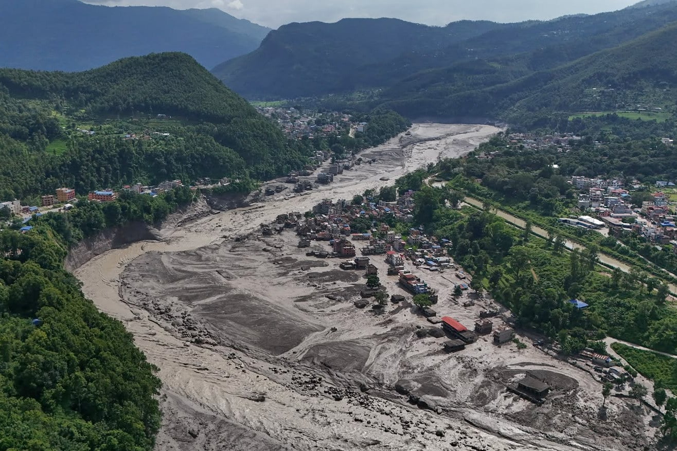 Damaged houses stand precariously near the swollen, debris-choked banks of the Trishuli River after flash floods in Nepal’s Nuwakot district on Wednesday. Photo: AP