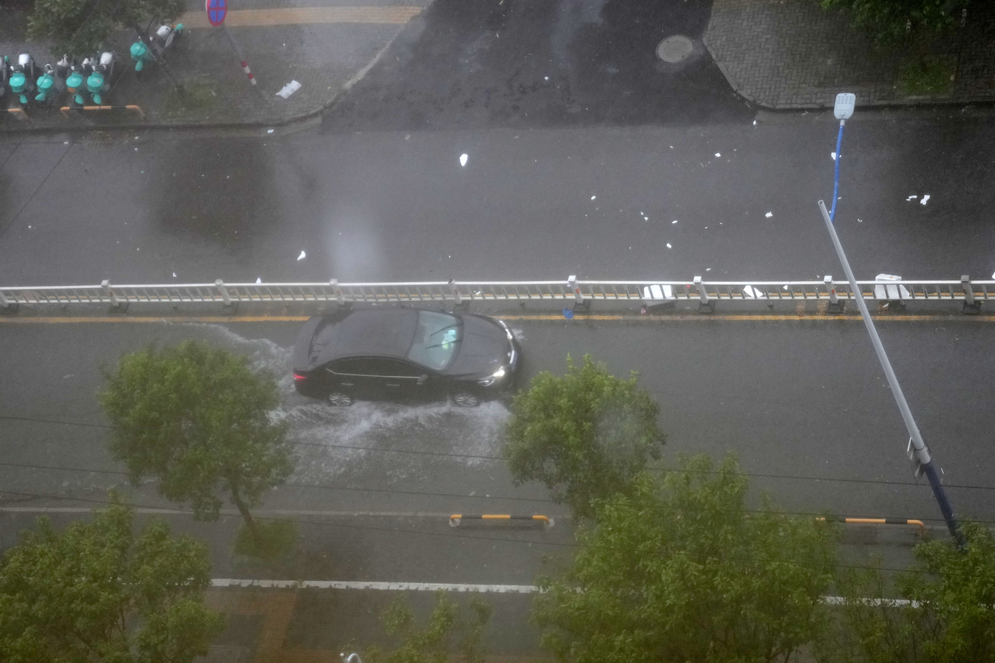 On Friday, a motorist navigates flooding in Wenzhou in Zhejiang province. Typhoon Saudel made landfall in Zhejiang, with up to Force 12 winds, according to the provincial weather observatory. Photo: Xinhua