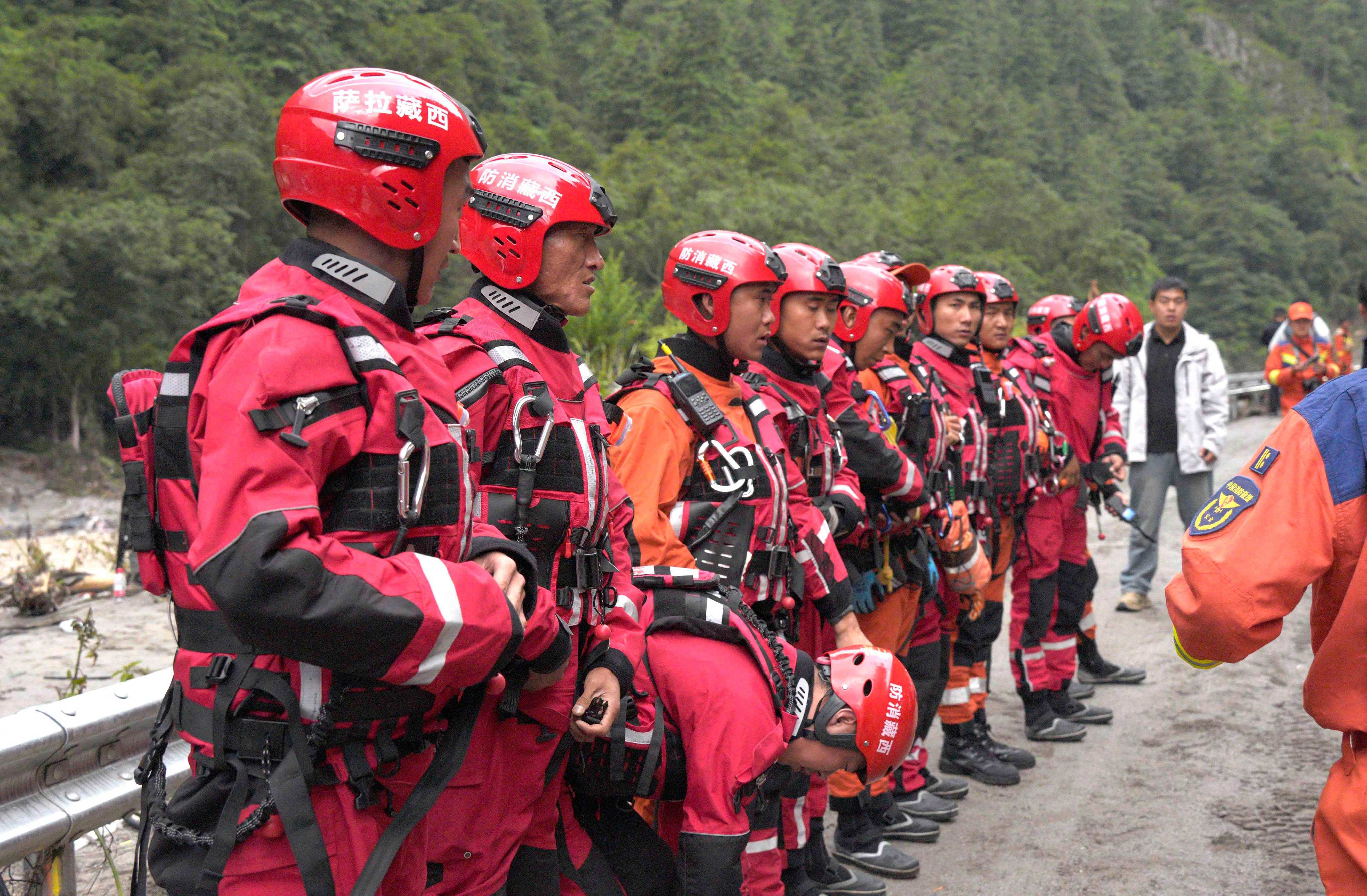 Fire and rescue personnel assemble before carrying out rescue operations on a section of a road leading to Gyirong Port in Tibet. Photo: CNS/AFP