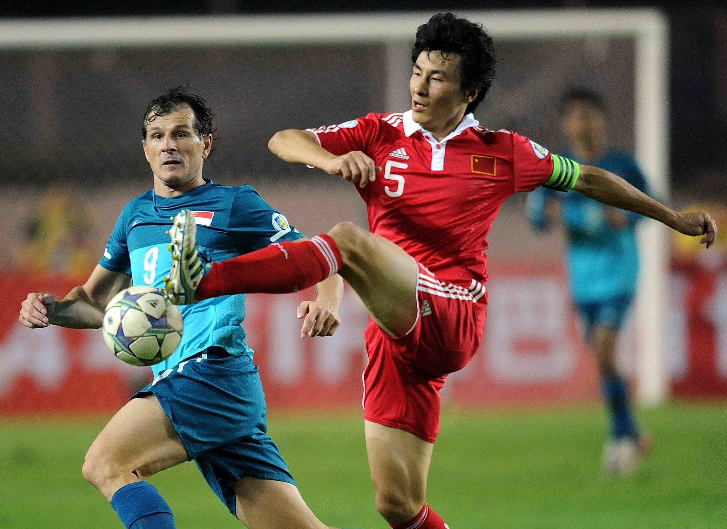 Li Weifeng (right) played for his country for 11 years and was a member of the only squad to reach a World Cup. Photo: AP