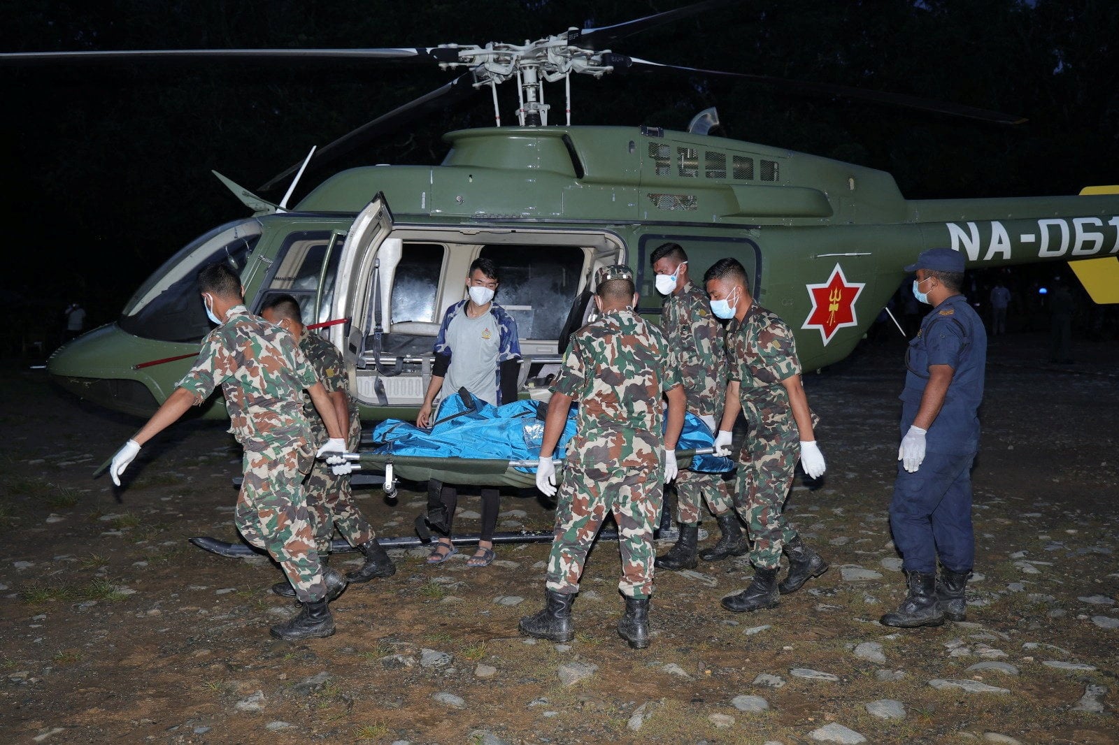 Army soldiers carry a victim who was airlifted from an area affected by flash floods and landslides in Nepal on Saturday. Photo: Nepal Army/Reuters