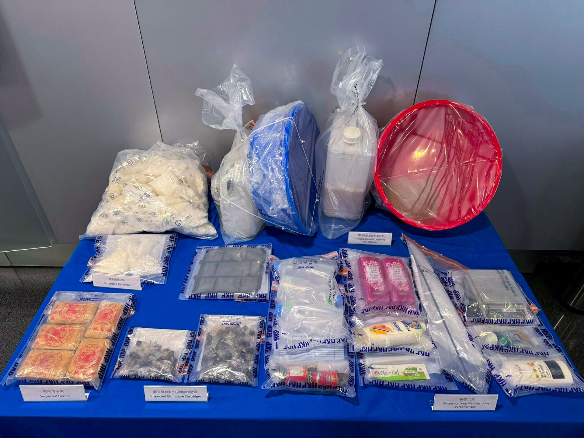 The suspected illegal drugs seized included 76kg of cocaine, 65kg of ketamine, 3.7 litres of liquid etomidate, and 6,400 etomidate vape pods.  Photo: Hong Kong Police