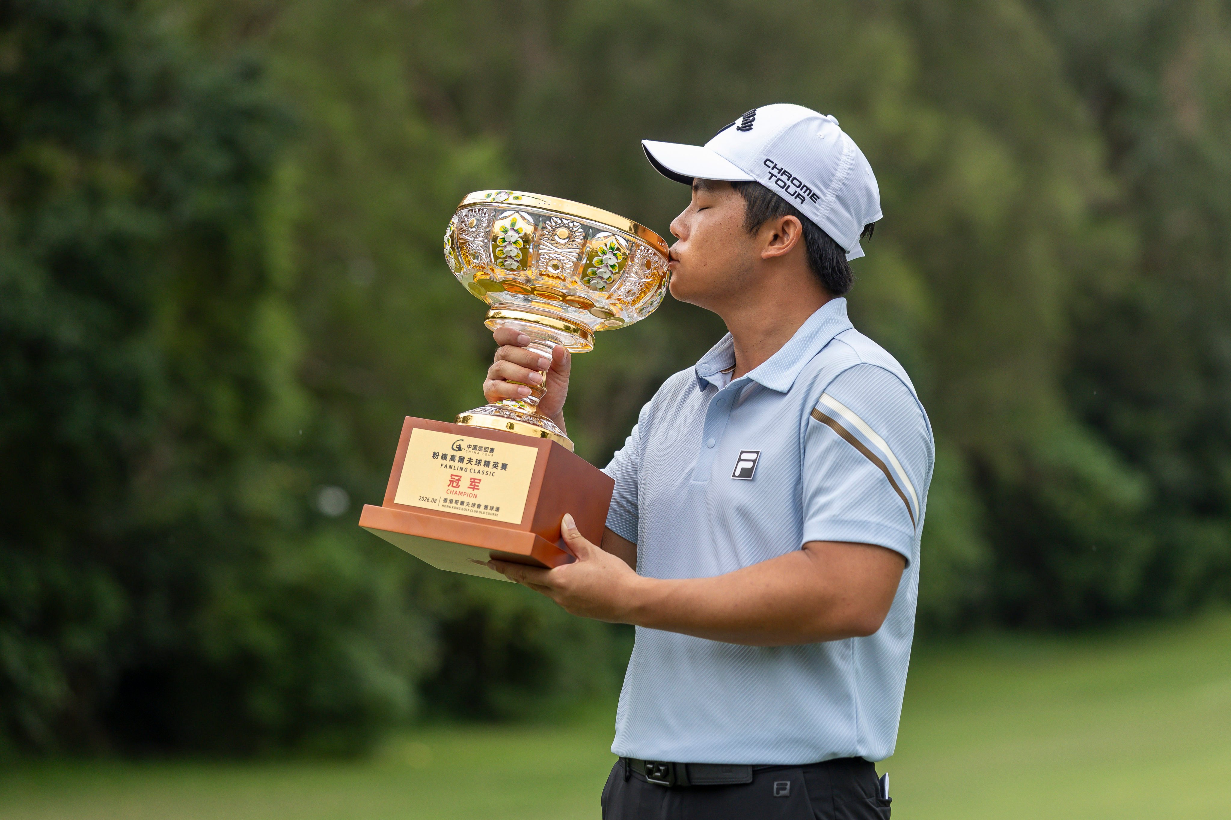 Isaac Lam celebrates with the trophy after winning the China Tour’s Fanling Classic at Hong Kong Golf Club. Photo: HKGC