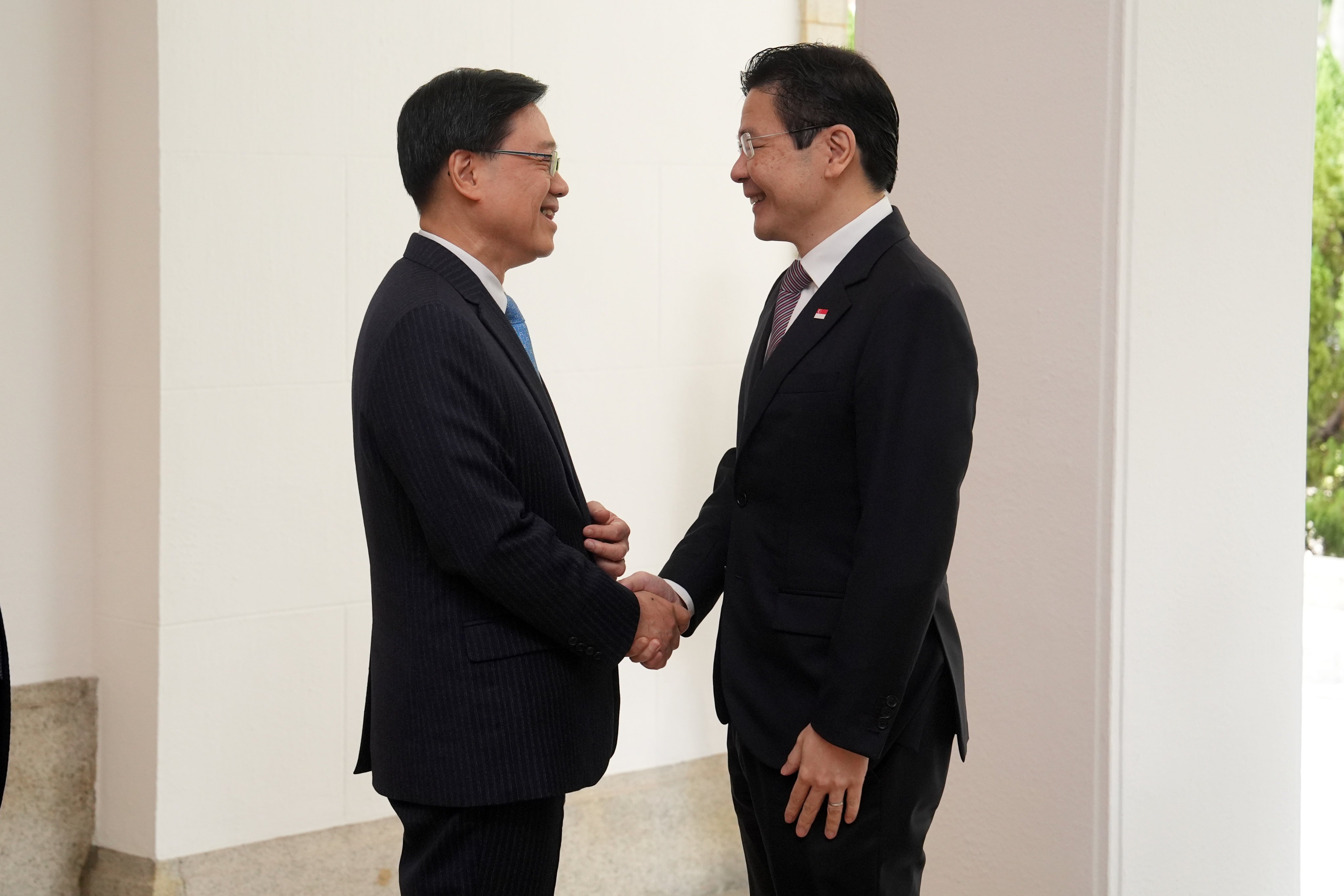 City leader John Lee (left) meets Singapore's Lawrence Wong in March. Photo: Elson Li