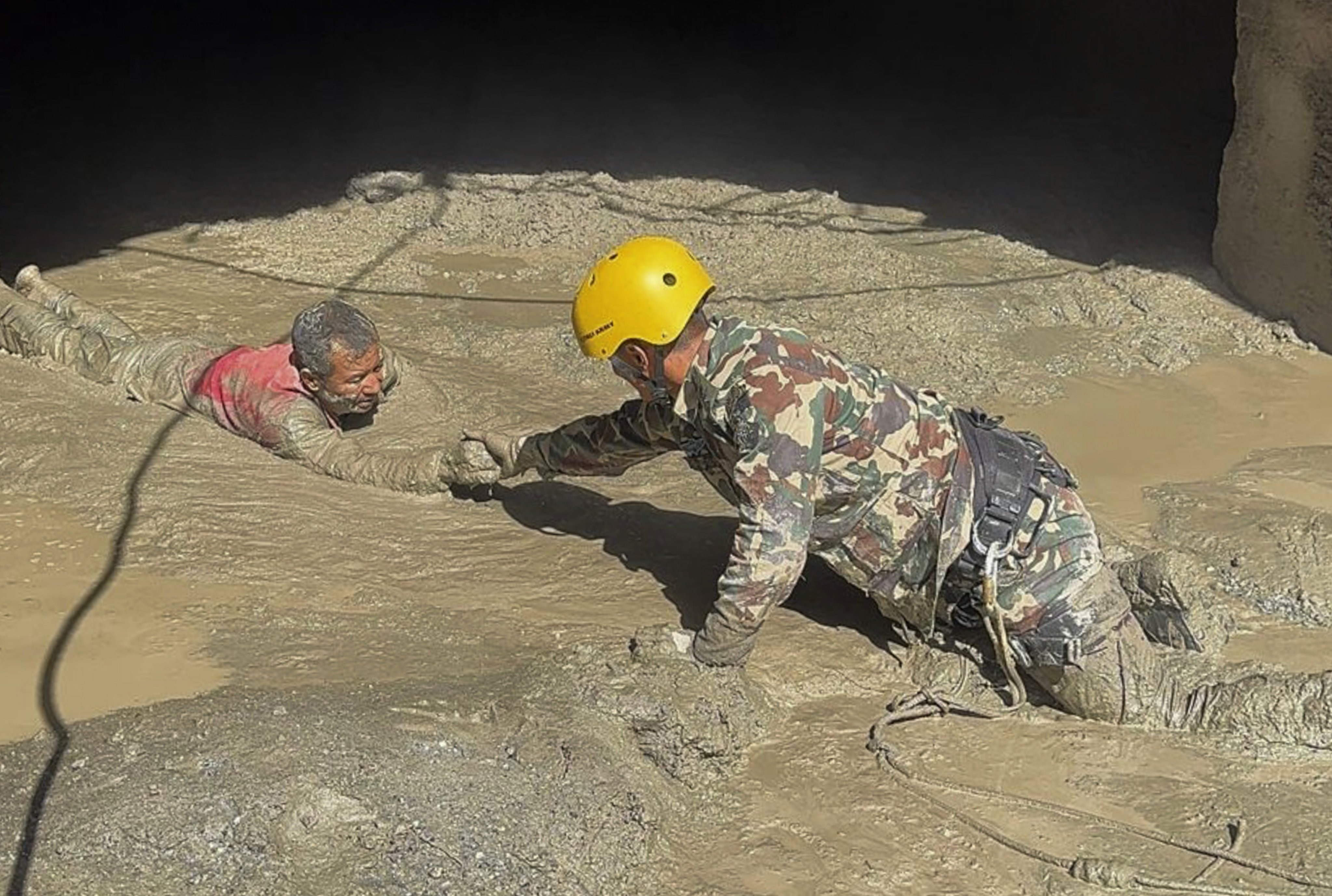 Nepal Army personnel rescue a survivor from a hydropower tunnel on Friday, following flash floods in Rasuwa District. Photo: Nepal Army via EPA