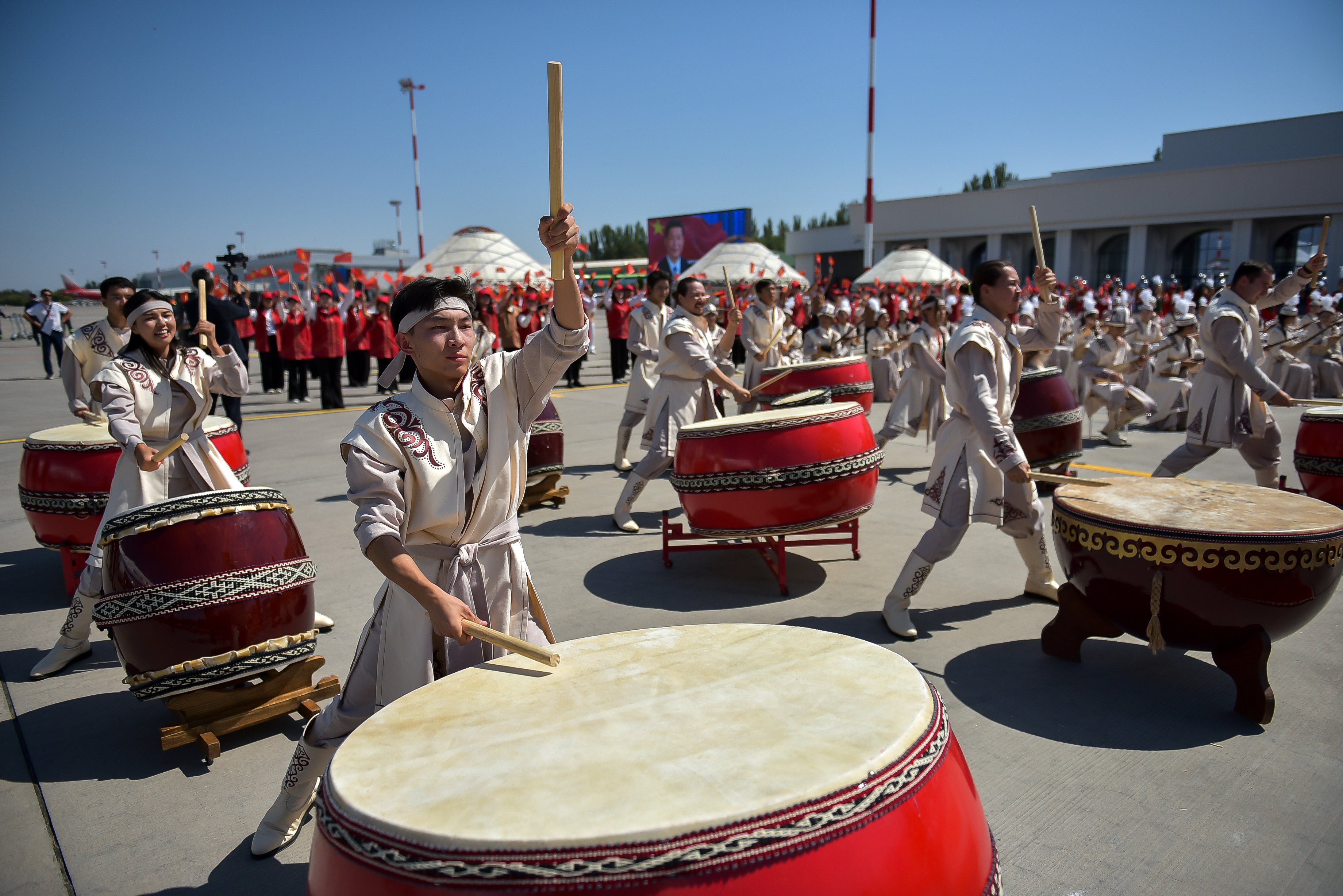 Performers beat the drums as Chinese President Xi Jinping and his wife Peng Liyuan arrive in Bishkek. Photo: Kyrgyzstan’s Presidential Press Office via AP