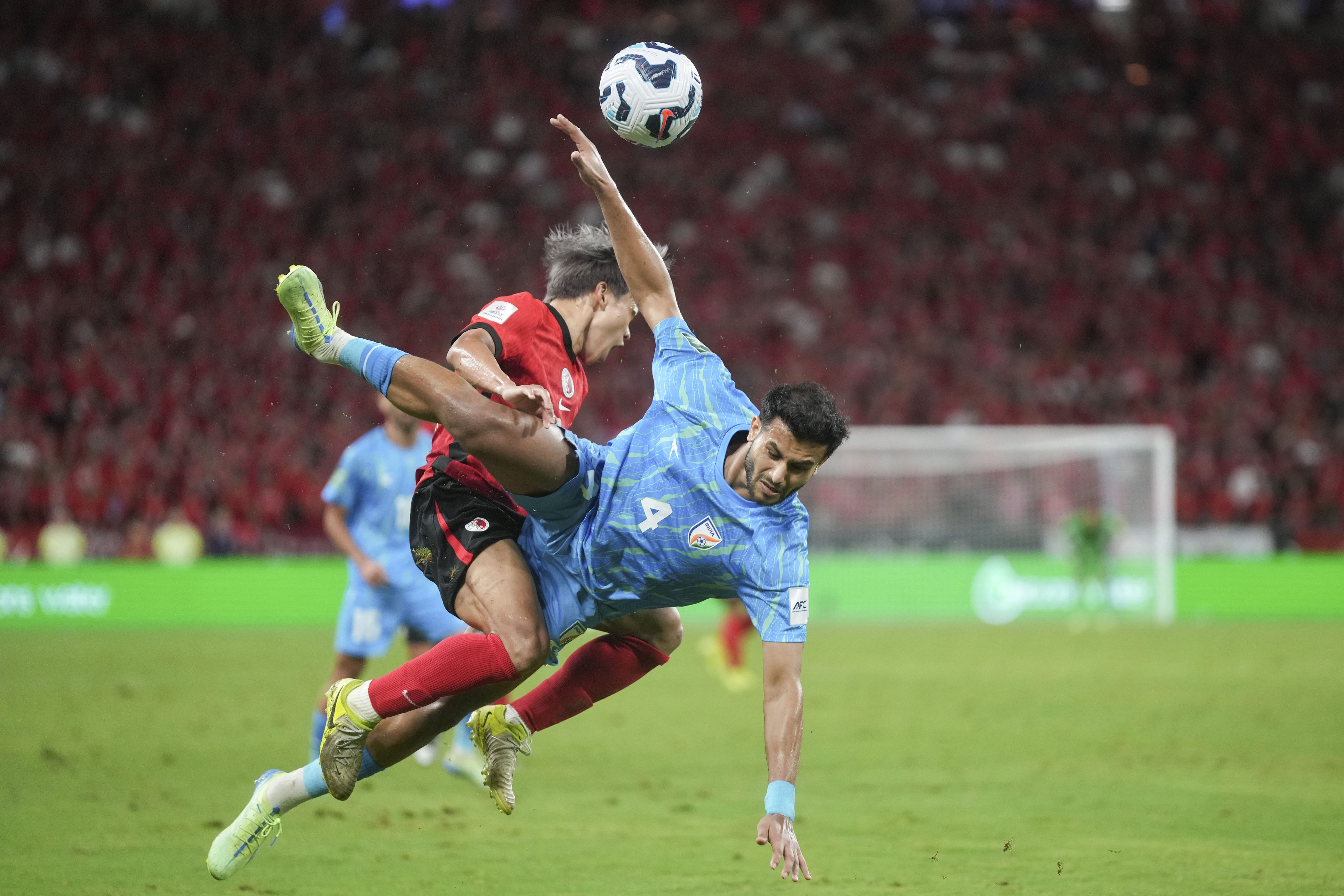 Hong Kong’s Yue Tsz-nam and India’s Anwar Ali clash during the an AFC Asian Cup qualifier at Kai Tak Stadium. Photo: Elson Li