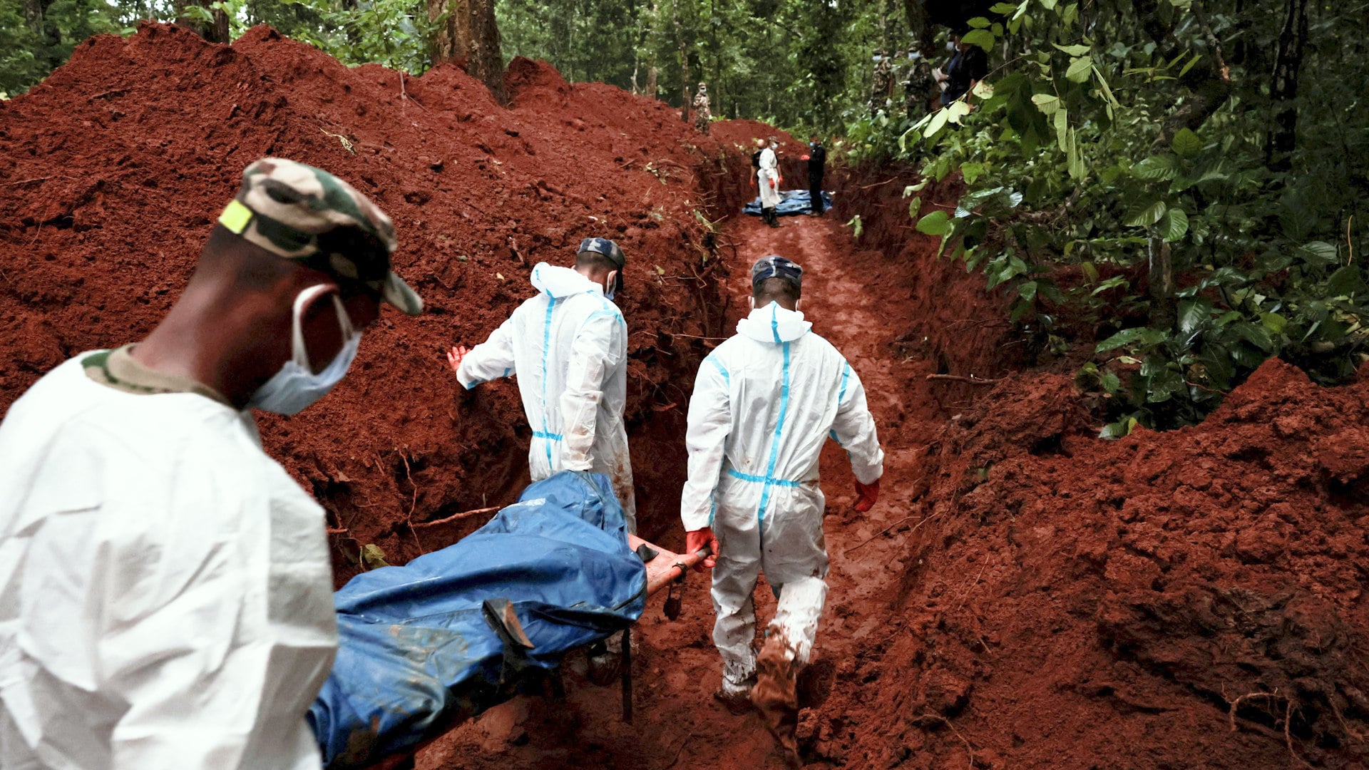 Armed Police Force (APF) officers work on transporting bodies to the pit at Devghat mass burial site for victims of deadly flash floods and mudslides in Chitwan, Nepal, August 30, 2026.