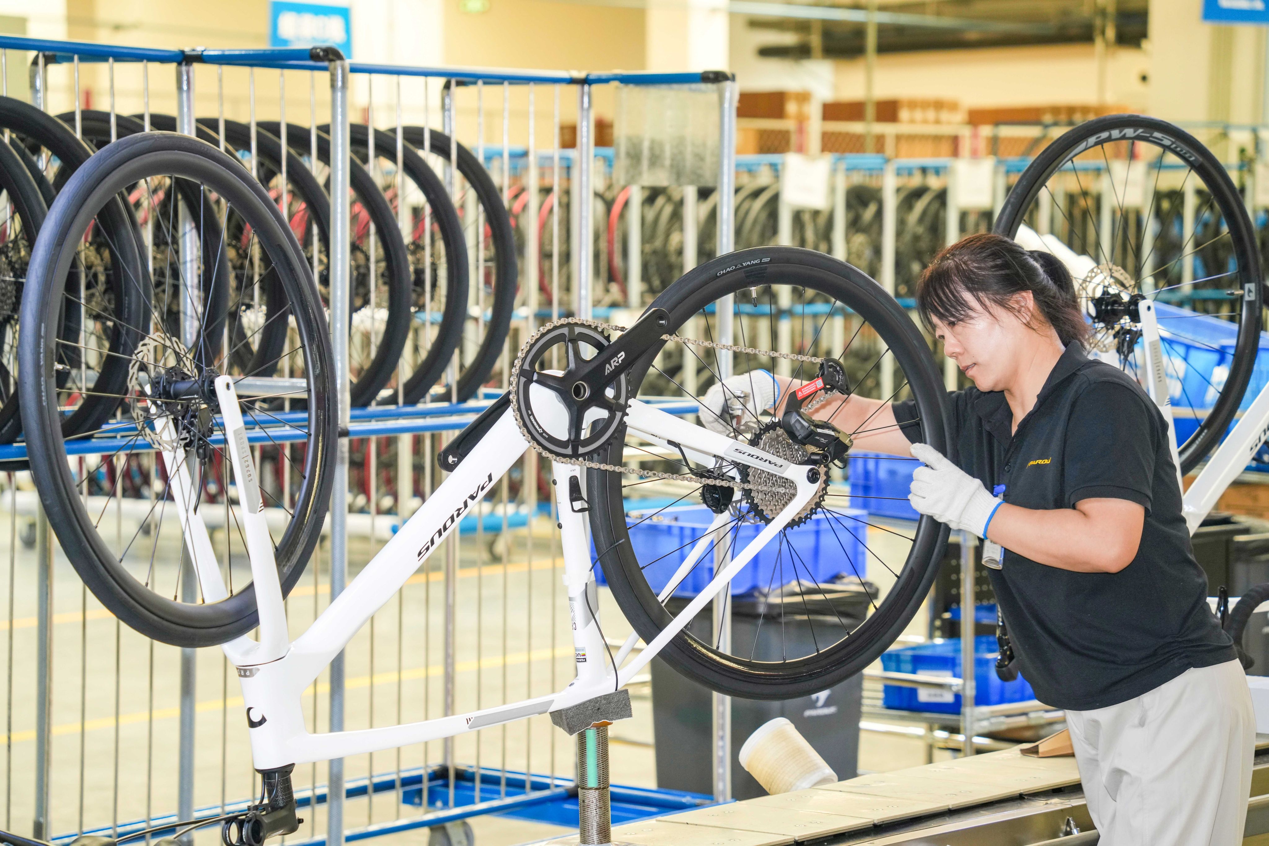 A worker assembles a carbon fibre bicycle at a production workshop in China’s Shandong province. Photo: Xinhua