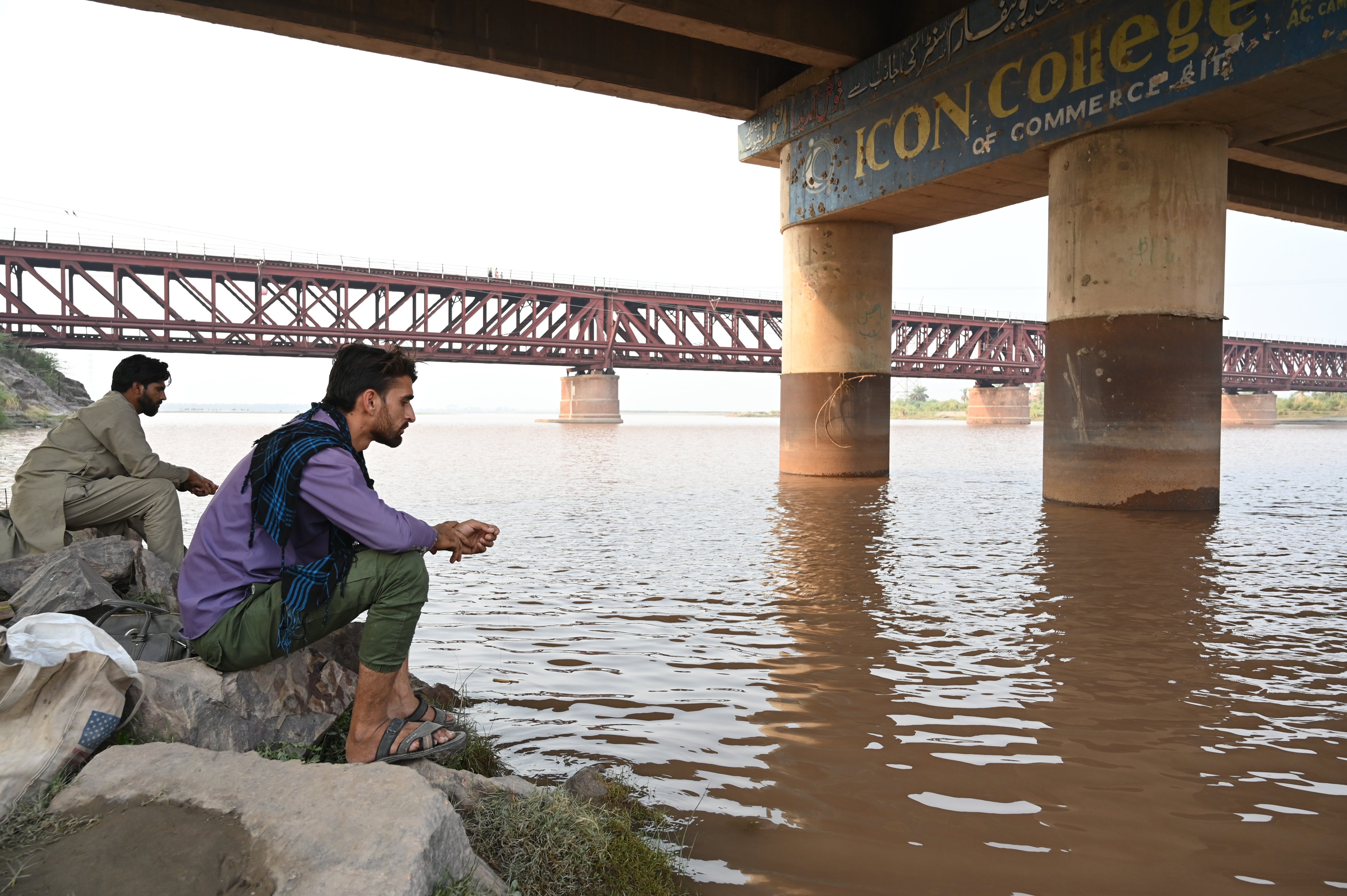 People sit on the bank of the river Chenab flowing through Chiniot, Punjab province, Pakistan, in May last year. India  halted water flow from Chenab into Pakistan amid rising tensions following a terrorist attack in Kashmir. Photo: EPA-EFE