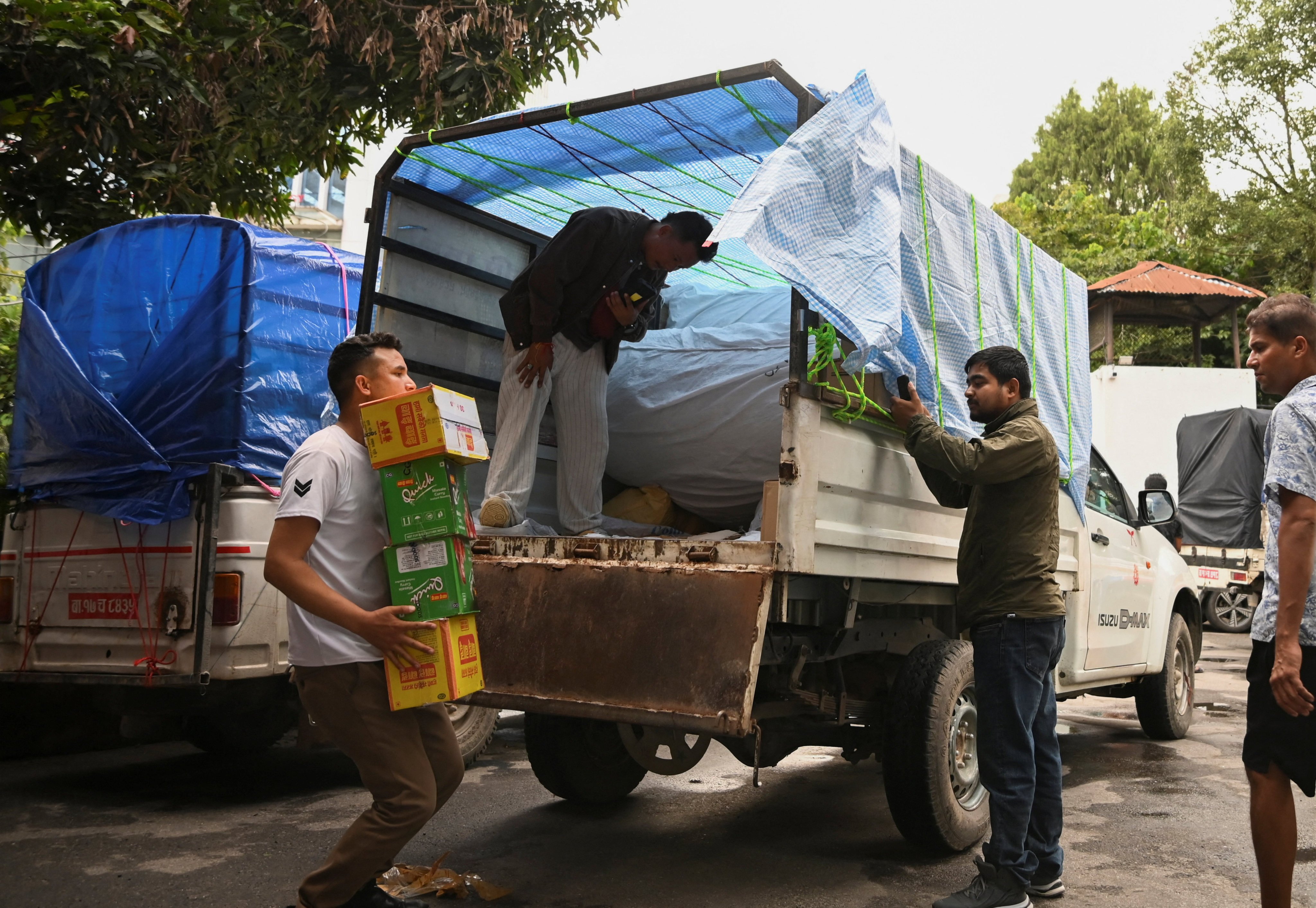 Volunteers in Kathmandu load relief supplies onto a vehicle bound for the flood-affected Rasuwa district of Nepal on Sunday. Photo: Reuters