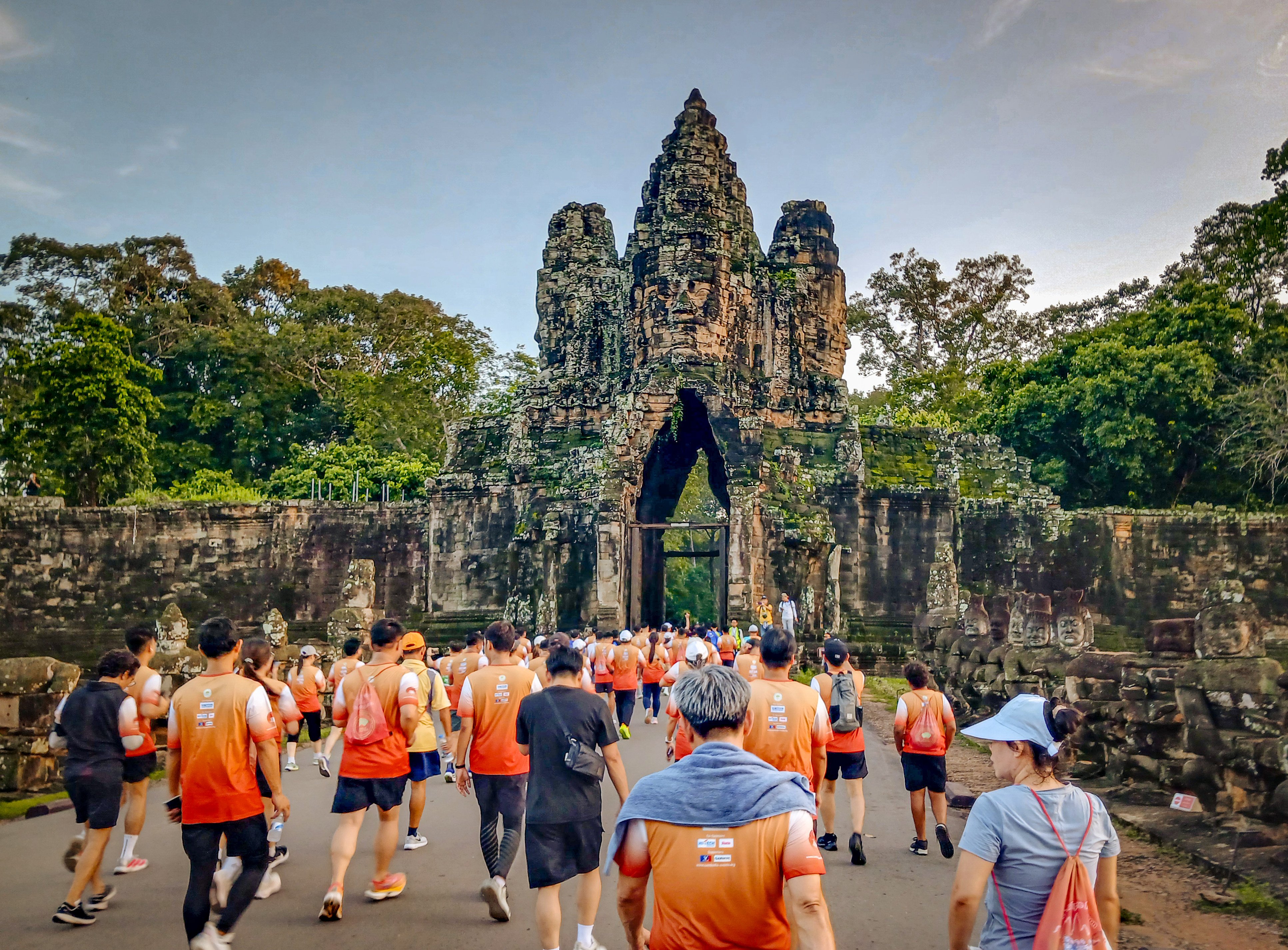 Competitors tackling the 10km race make their way through the South Gate of Angkor Thom, in Siem Reap, Cambodia. Photo: Marissa Carruthers