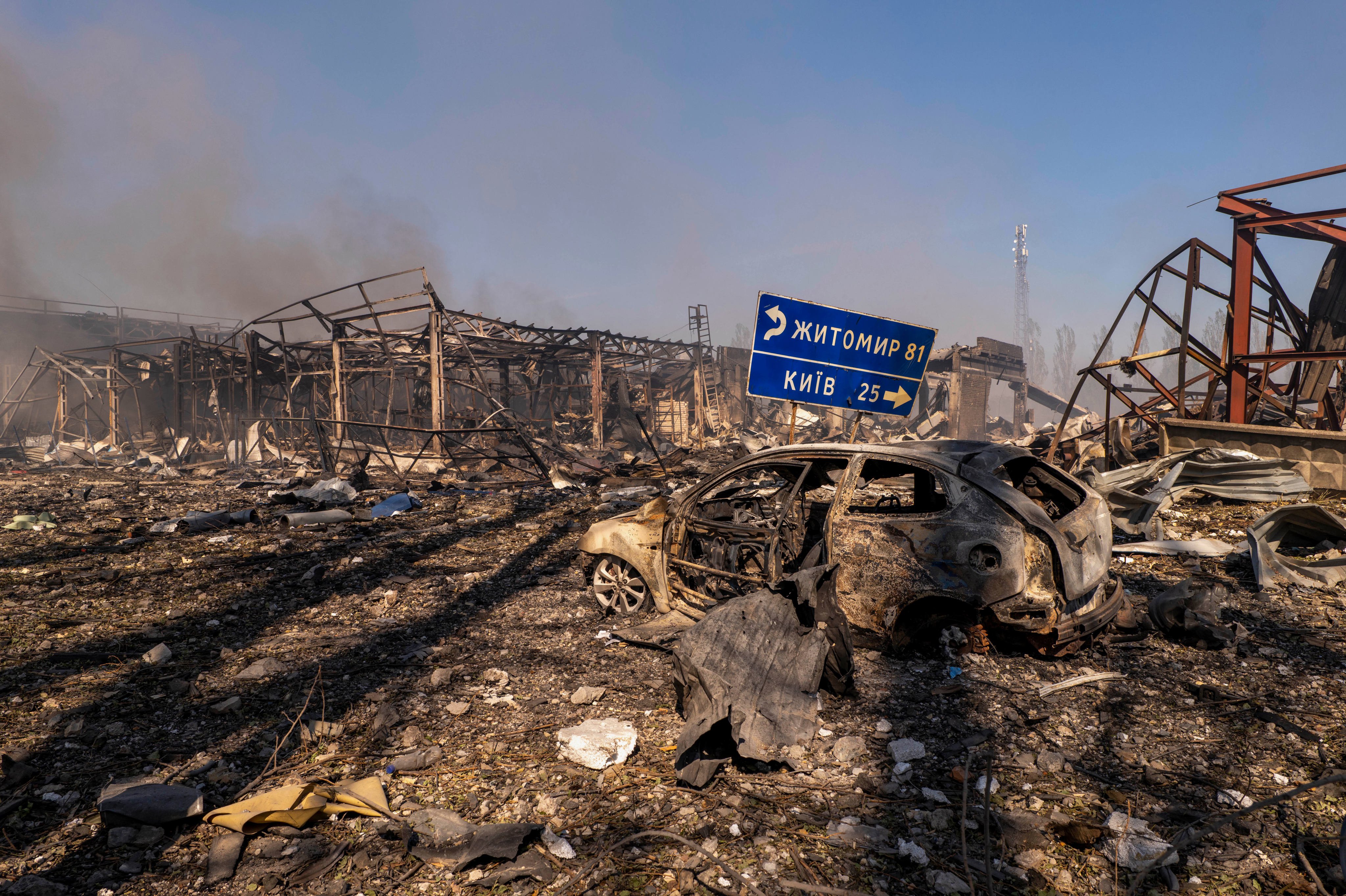 A burnt-out car and destroyed buildings following a Russian strike on a warehouse in the village of Myla, west of Kyiv, Ukraine. Photo: AP