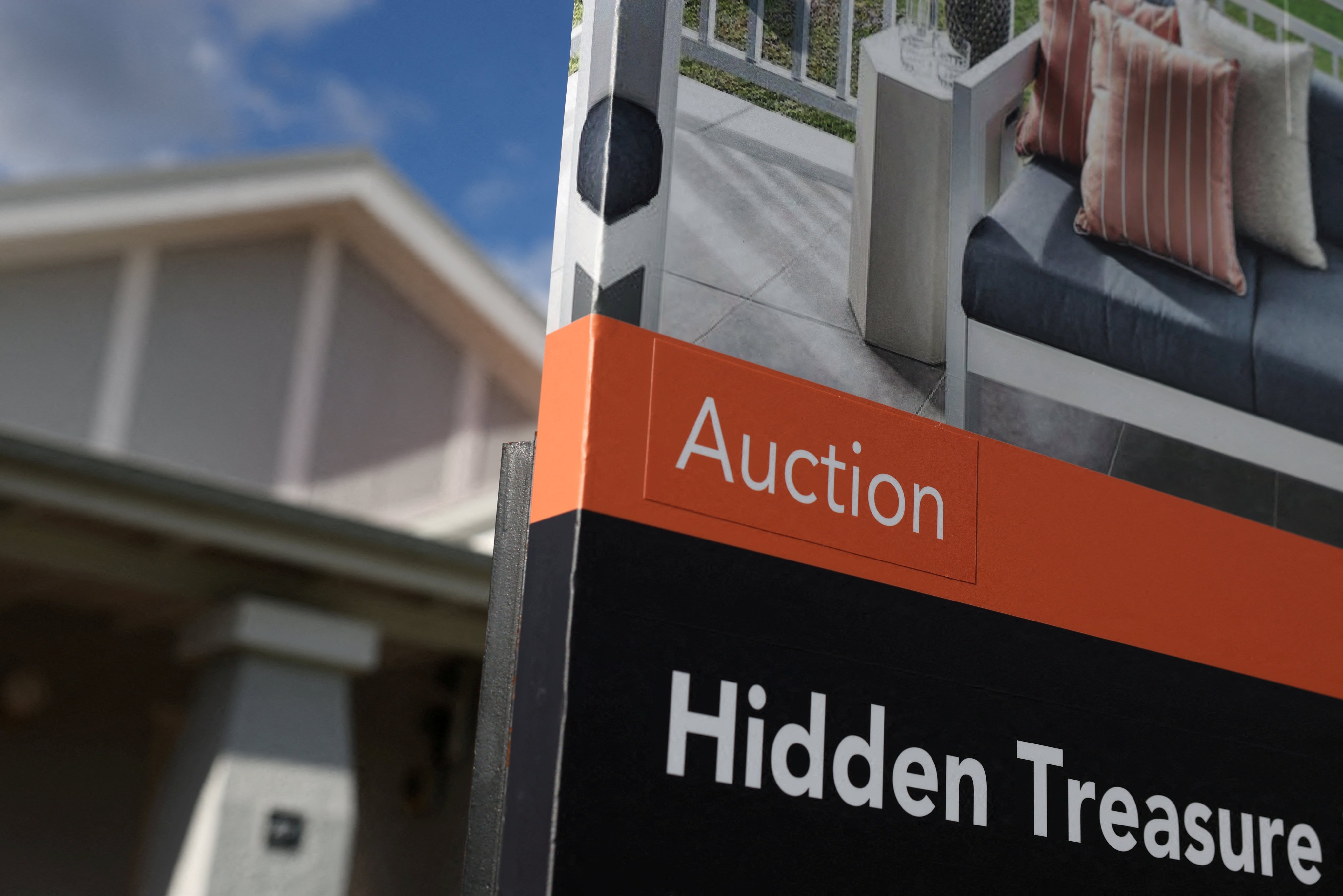 An auction sign stands outside a house in Sydney on June 22. Photo: Reuters