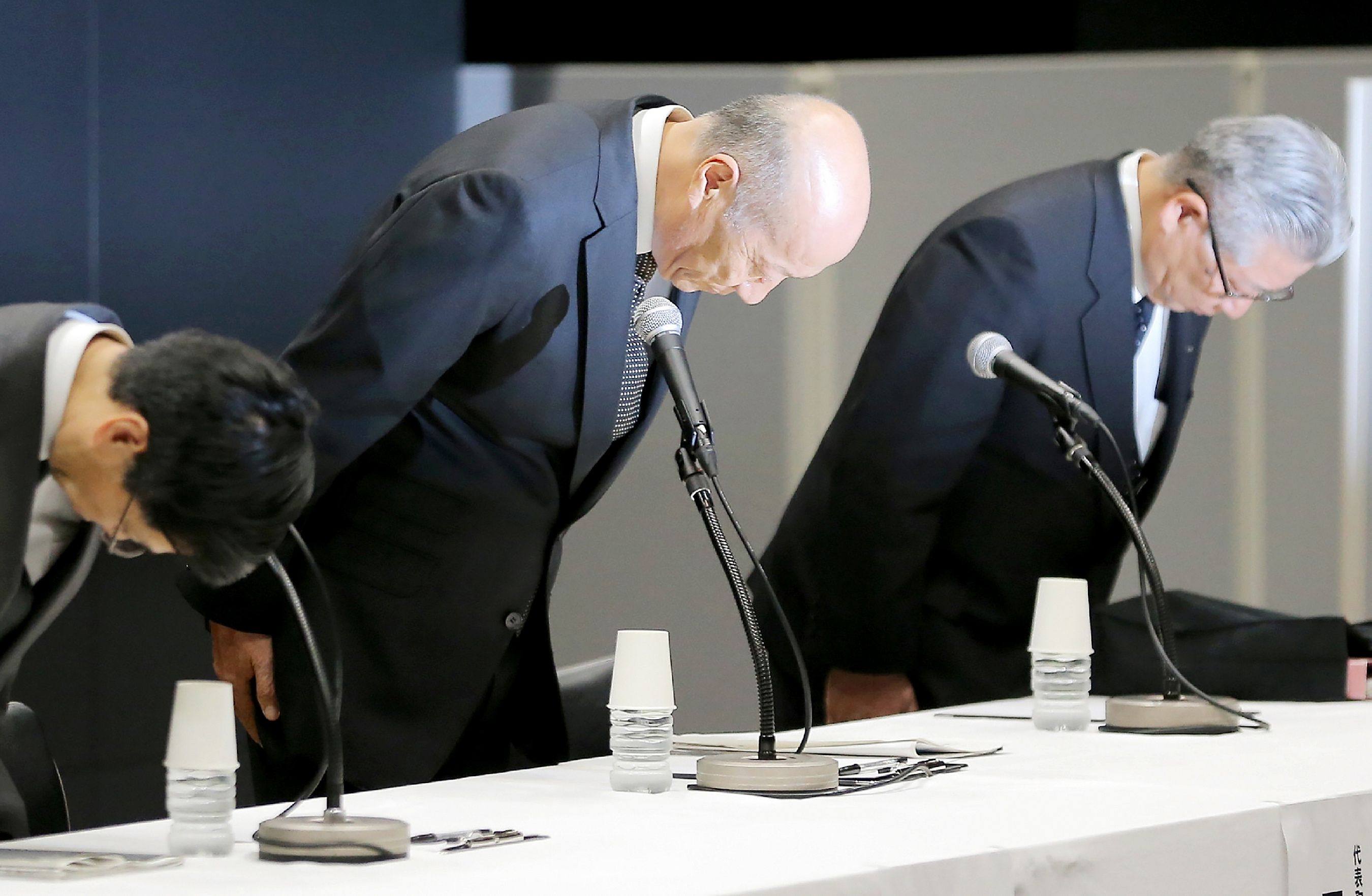 Then Dentsu president Tadashi Ishii (centre) bows as he announces his resignation on December 28, 2016, after the suicide of a young employee is linked to allegations of extreme overwork at the company. Photo: Jiji Press/AFP