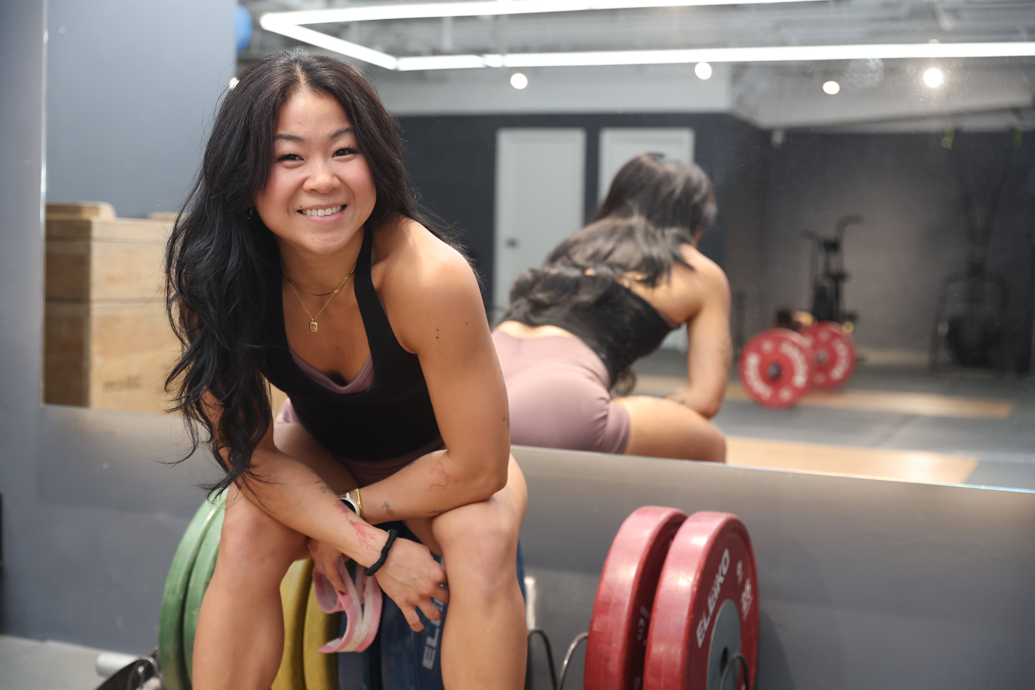Professional weightlifter Tammy Wong rests mid-workout at Powerhouse Barbell Club in Central, Hong Kong. The three-time British weightlifting champion talks about her unexpected journey in the sport, why strength and femininity are not mutually exclusive, and her vision to help more women start lifting. Photo: Edmond So