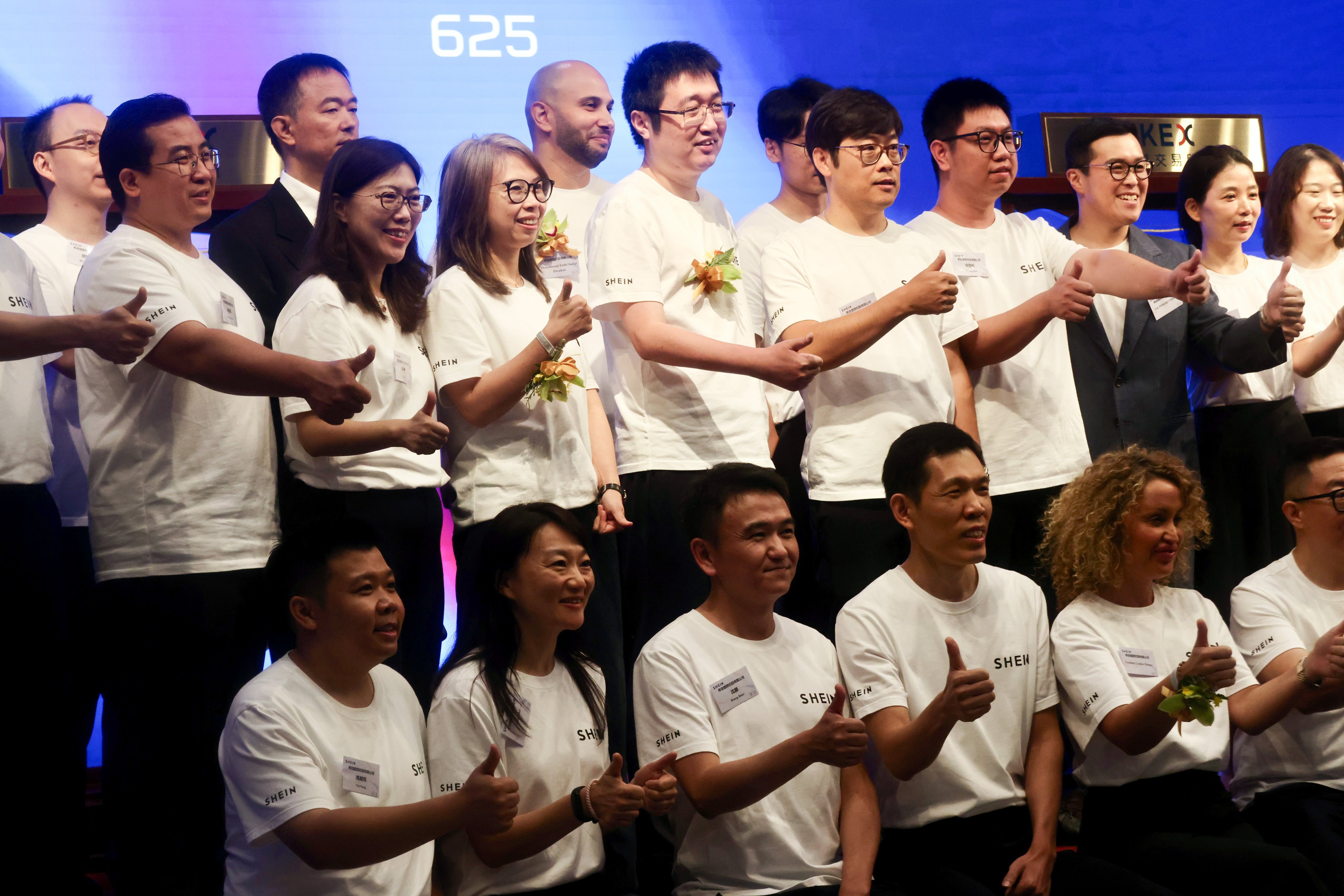 Shein Global Holdings employees, including founder Sky Xu (centre, top row) at the listing ceremony in Hong Kong on Tuesday. Photo: Jonathan Wong