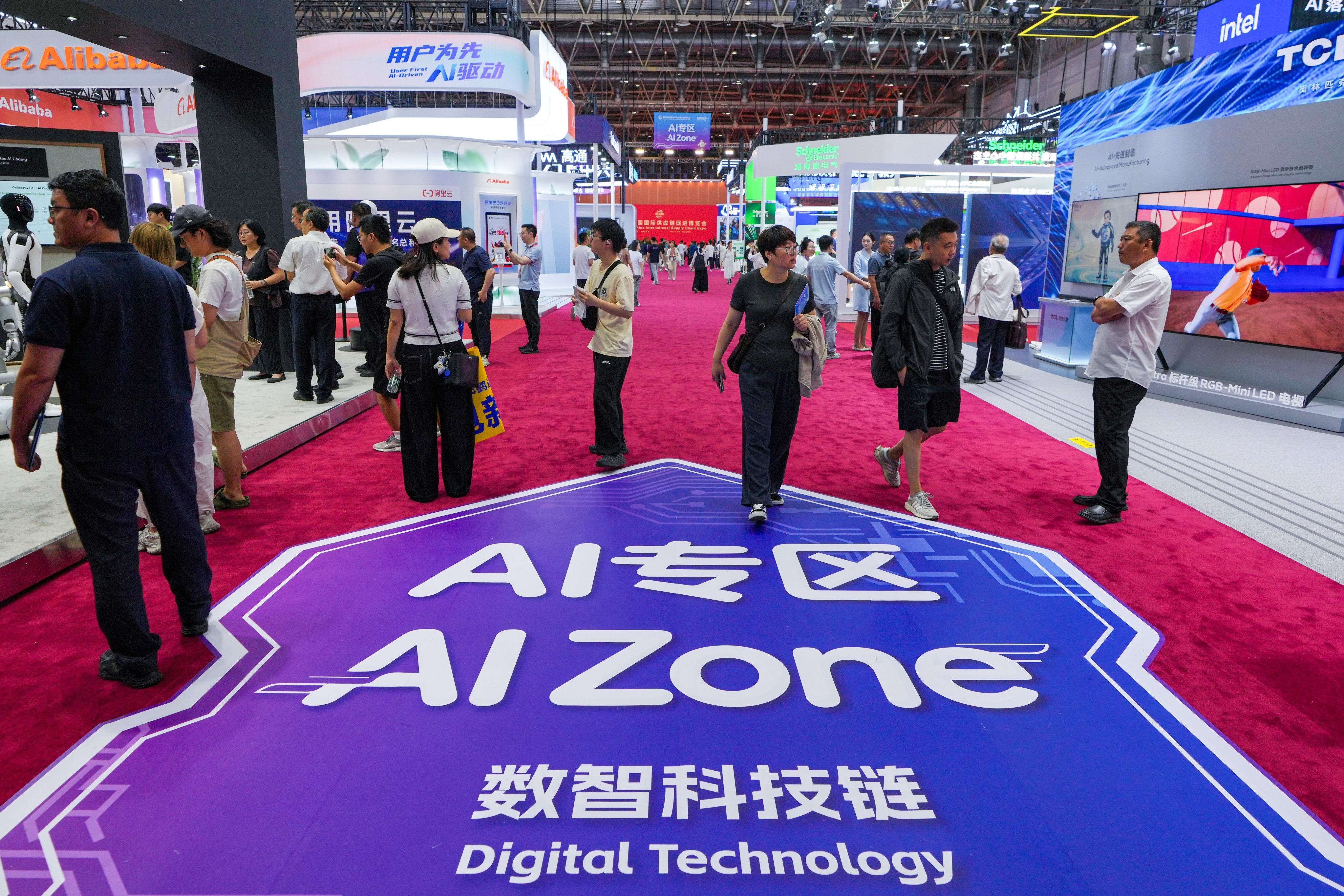 Visitors tour exhibition booths  at the China International Supply Chain Expo in Beijing on June 25. Photo: AP