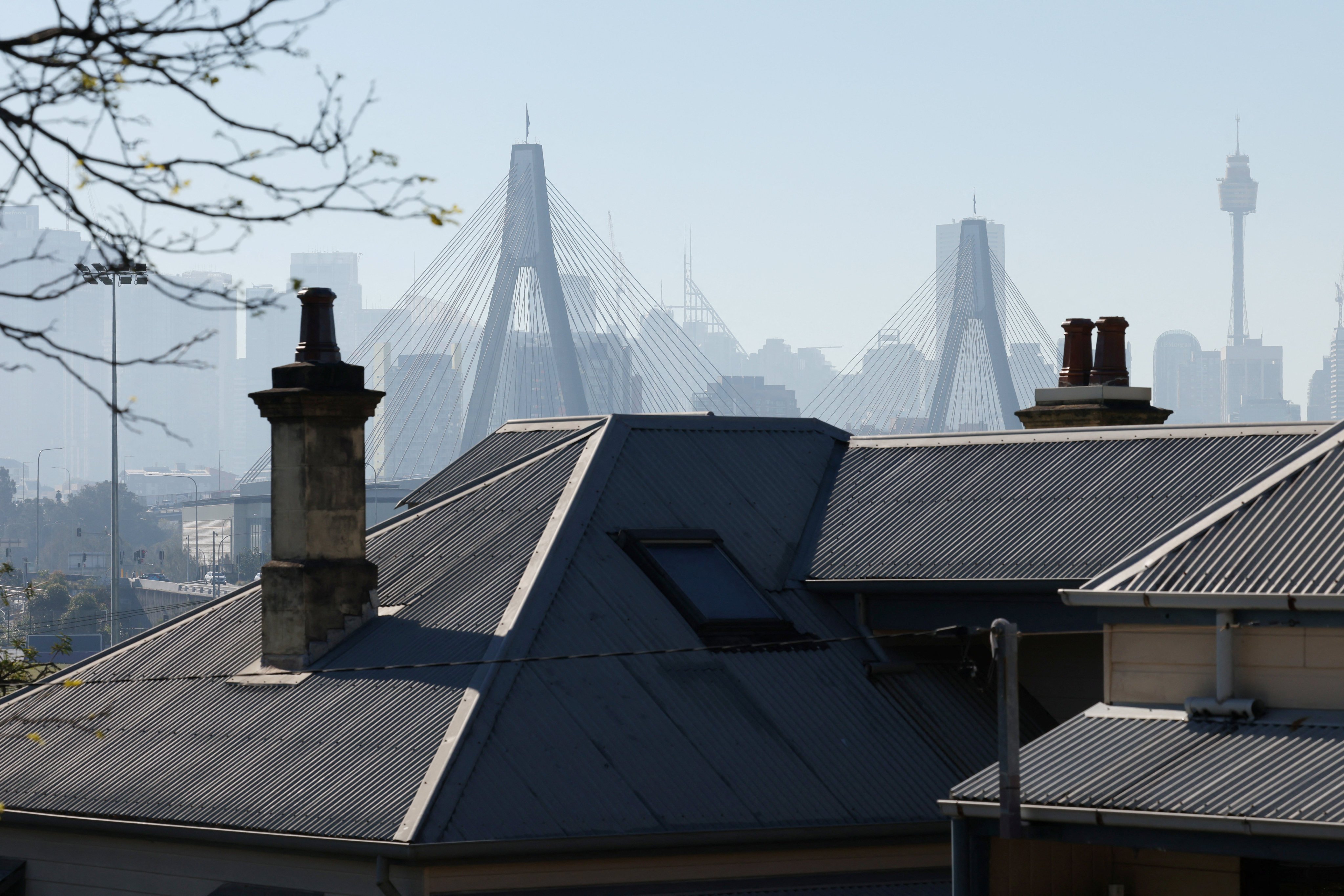 Residential properties stand against a backdrop of the city skyline in Sydney on Tuesday. Photo: Reuters