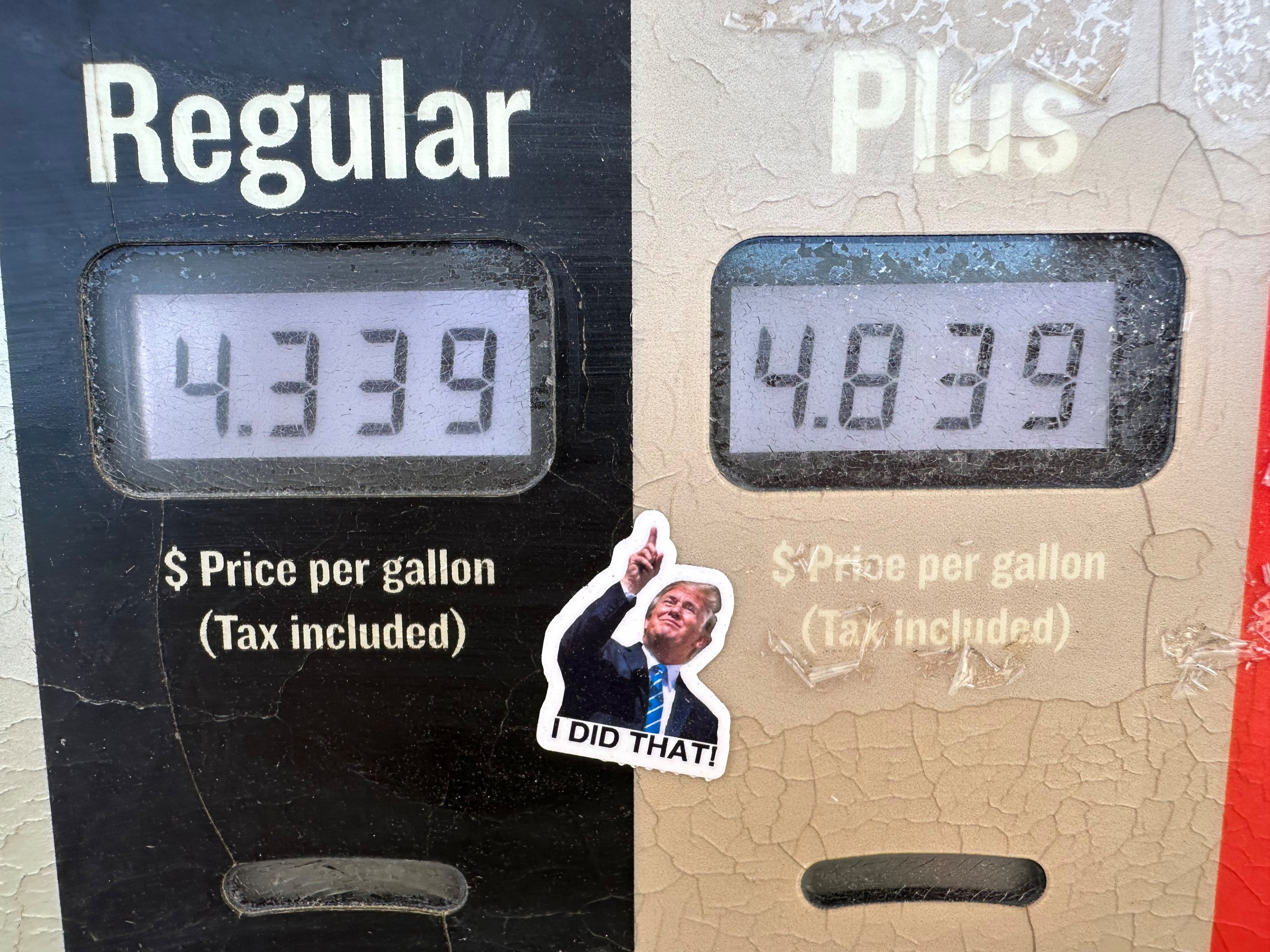 A sticker depicting US President Donald Trump pointing to high prices at a fuel pump. Photo: AFP