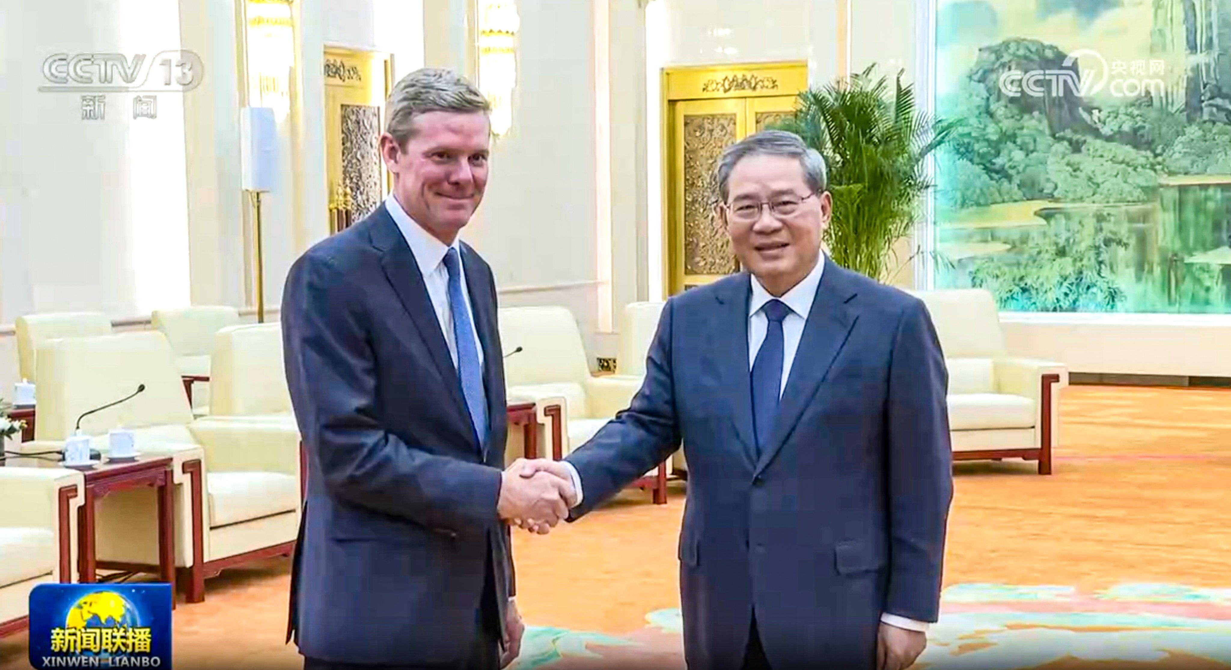 Chinese Premier Li Qiang, right, shakes hands with Visa CEO Ryan McInerney during a meeting at the Great Hall of the People in Beijing on Tuesday. Photo: CCTV