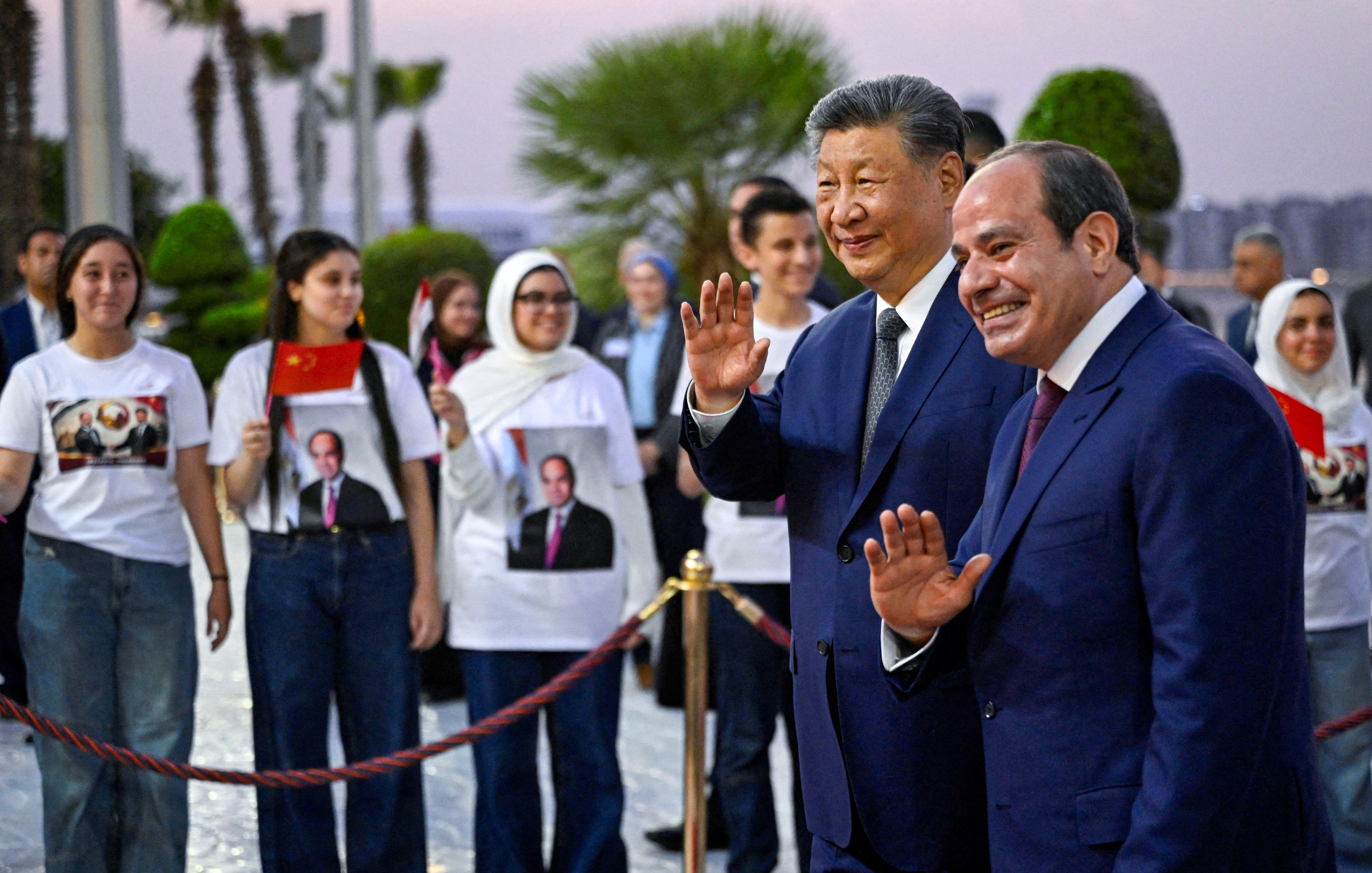 President Xi Jinping and Egyptian President Abdel-Fattah el-Sisi wave to the crowd after Xi’s arrival at Cairo International Airport on Tuesday. Photo: Reuters
