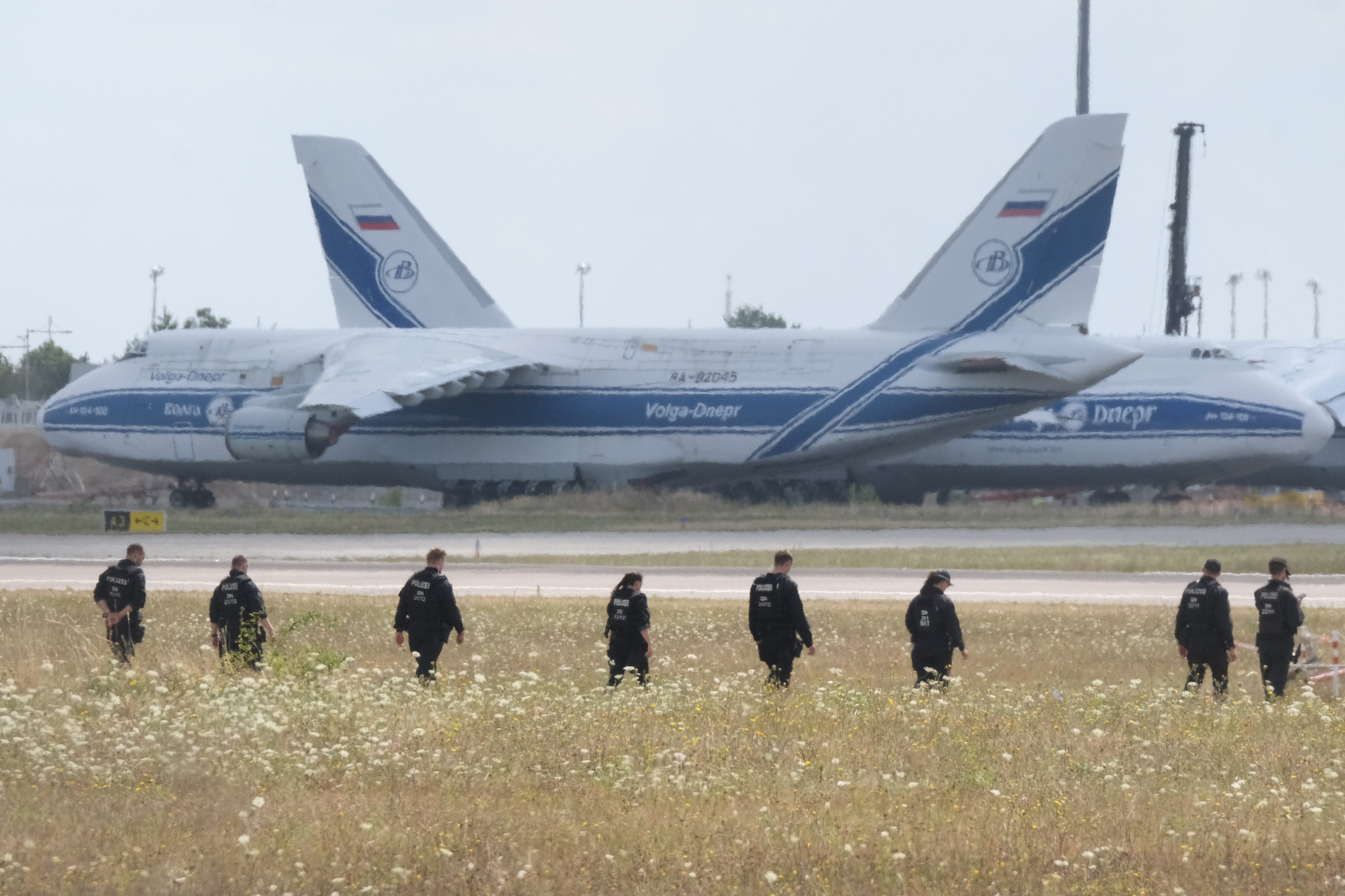 Police officers search a field on the grounds of Leipzig/Halle Airport in Germany in August after an attempted drone attack. Photo: dpa via AP