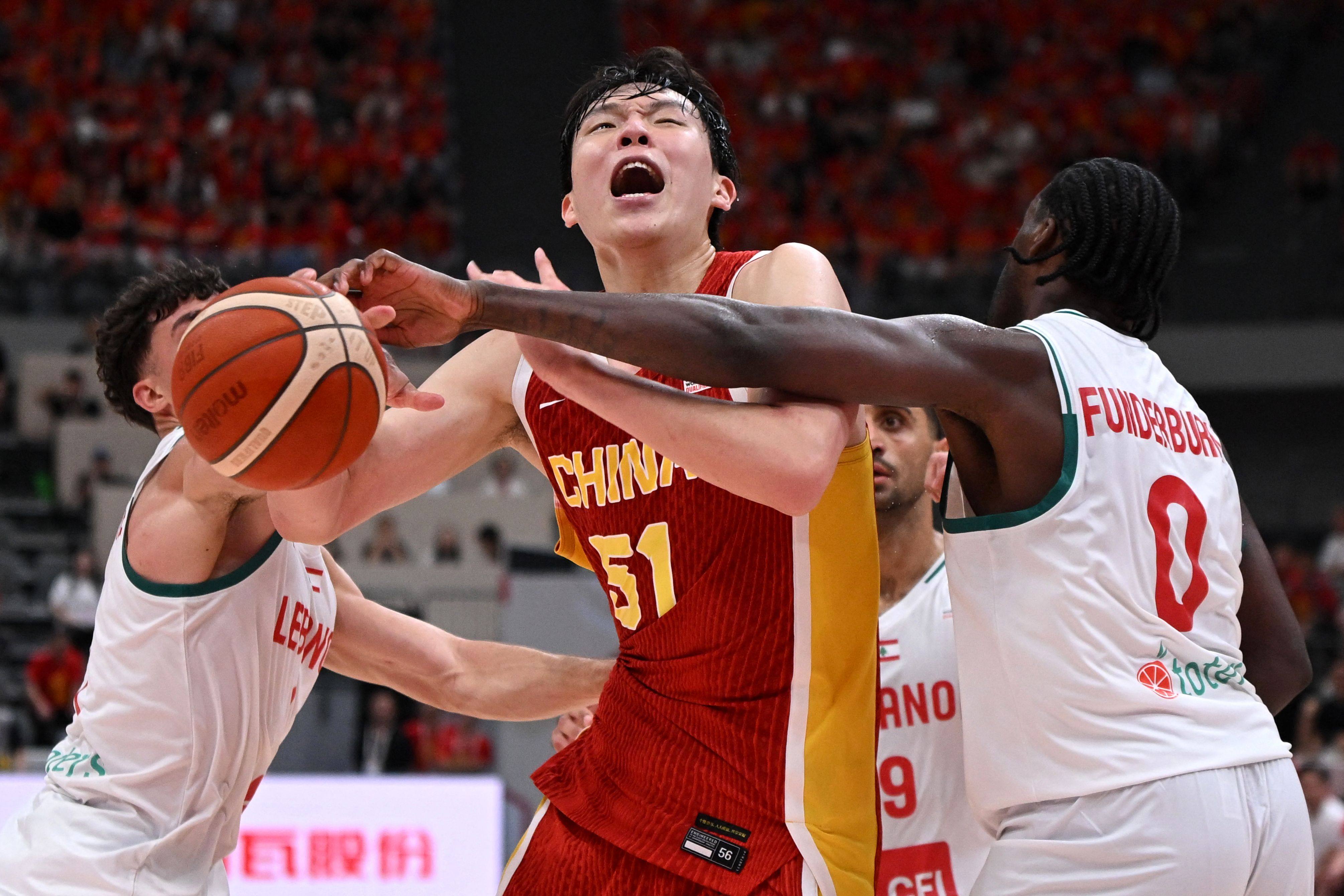 China’s Yang Hansen (centre) competes for the ball with Lebanon’s DJ Funderburk (right) and Omar Jamaleddine during their Fiba World Cup qualifier on Monday. Photo: AFP