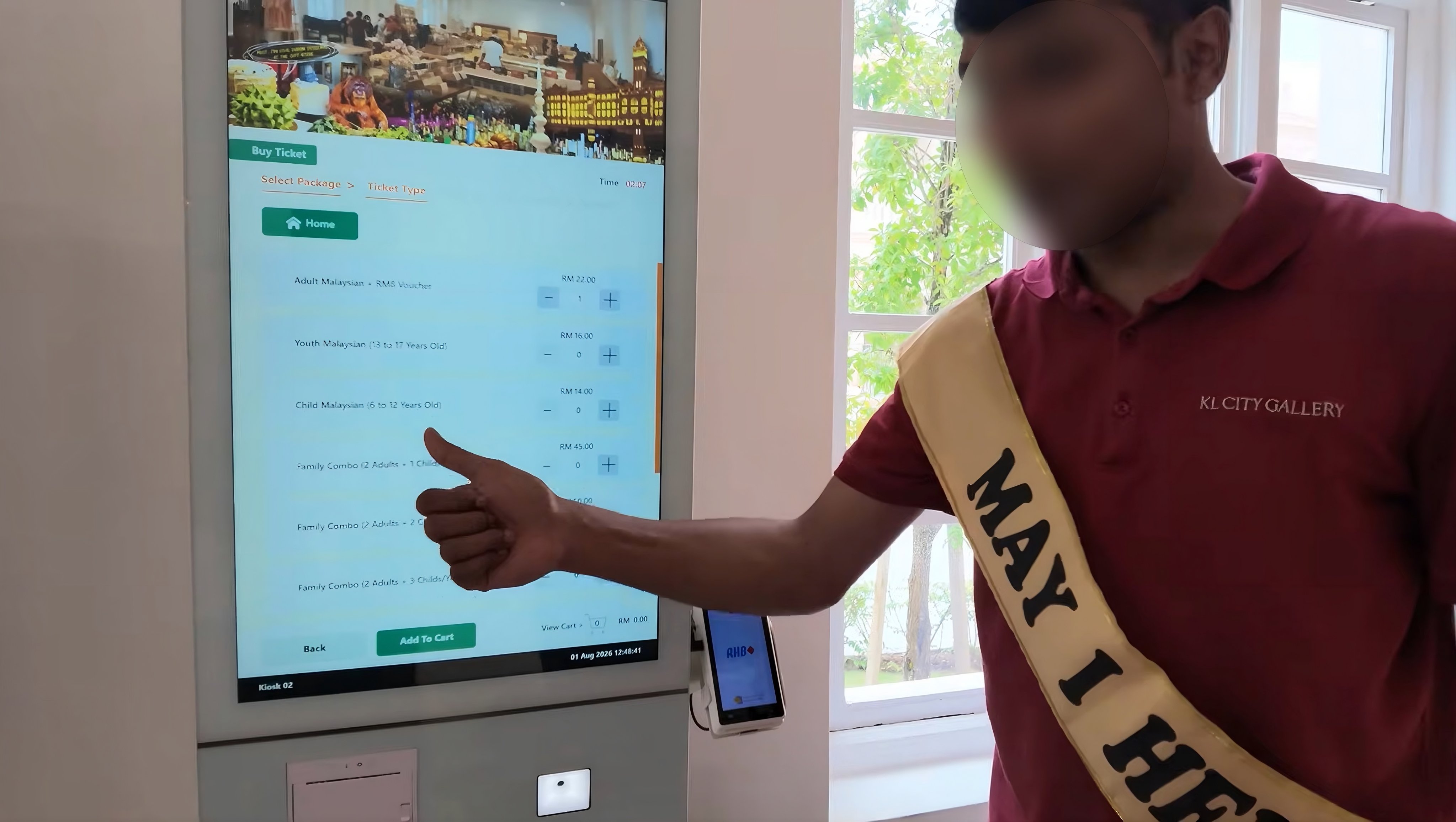 A still from a social media video shows a member of staff helping tourists at the KL City Gallery in the Sultan Abdul Samad Building, Kuala Lumpur, Malaysia. Photo: YouTube