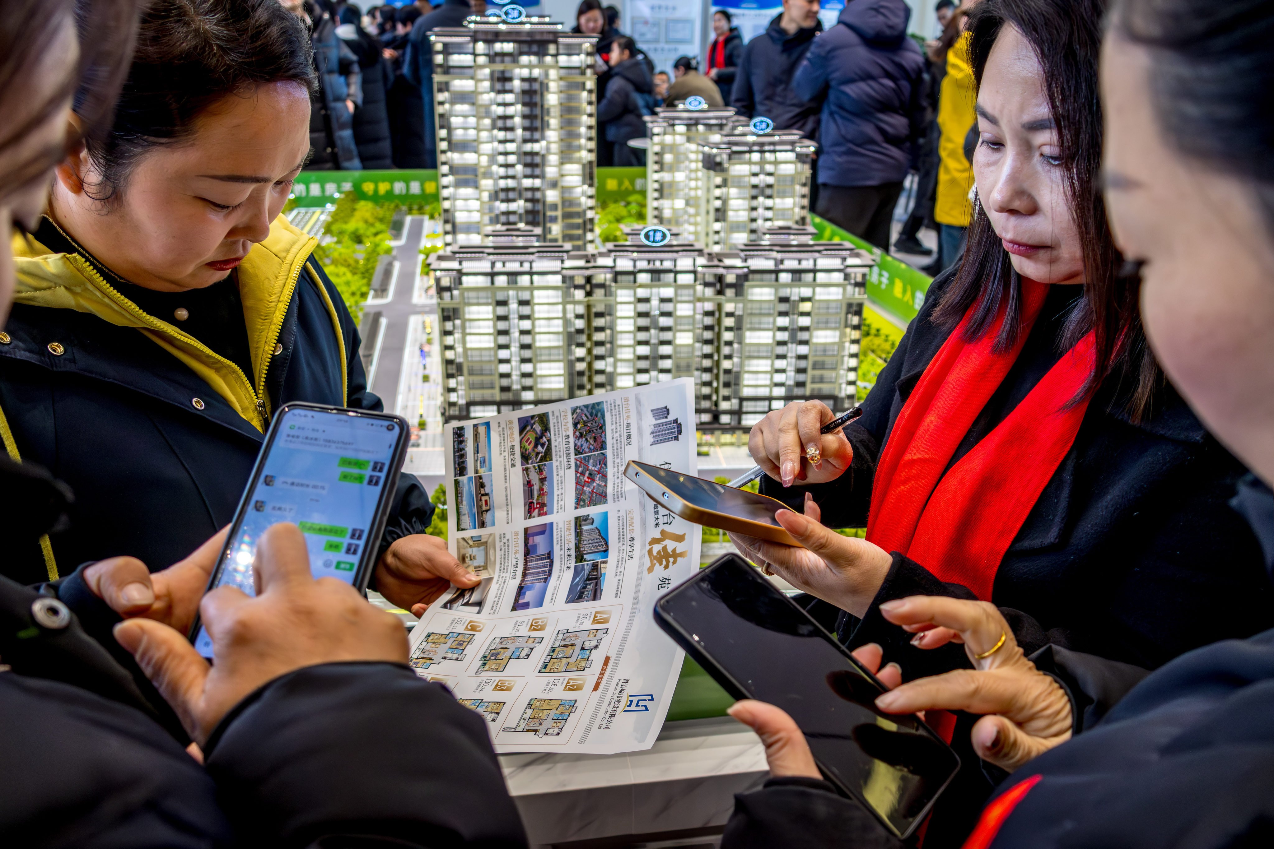 Potential homebuyers study options at a property sales office in Anyang City, China, on January 10, 2026. Photo: Costfoto/NurPhoto via Getty Images