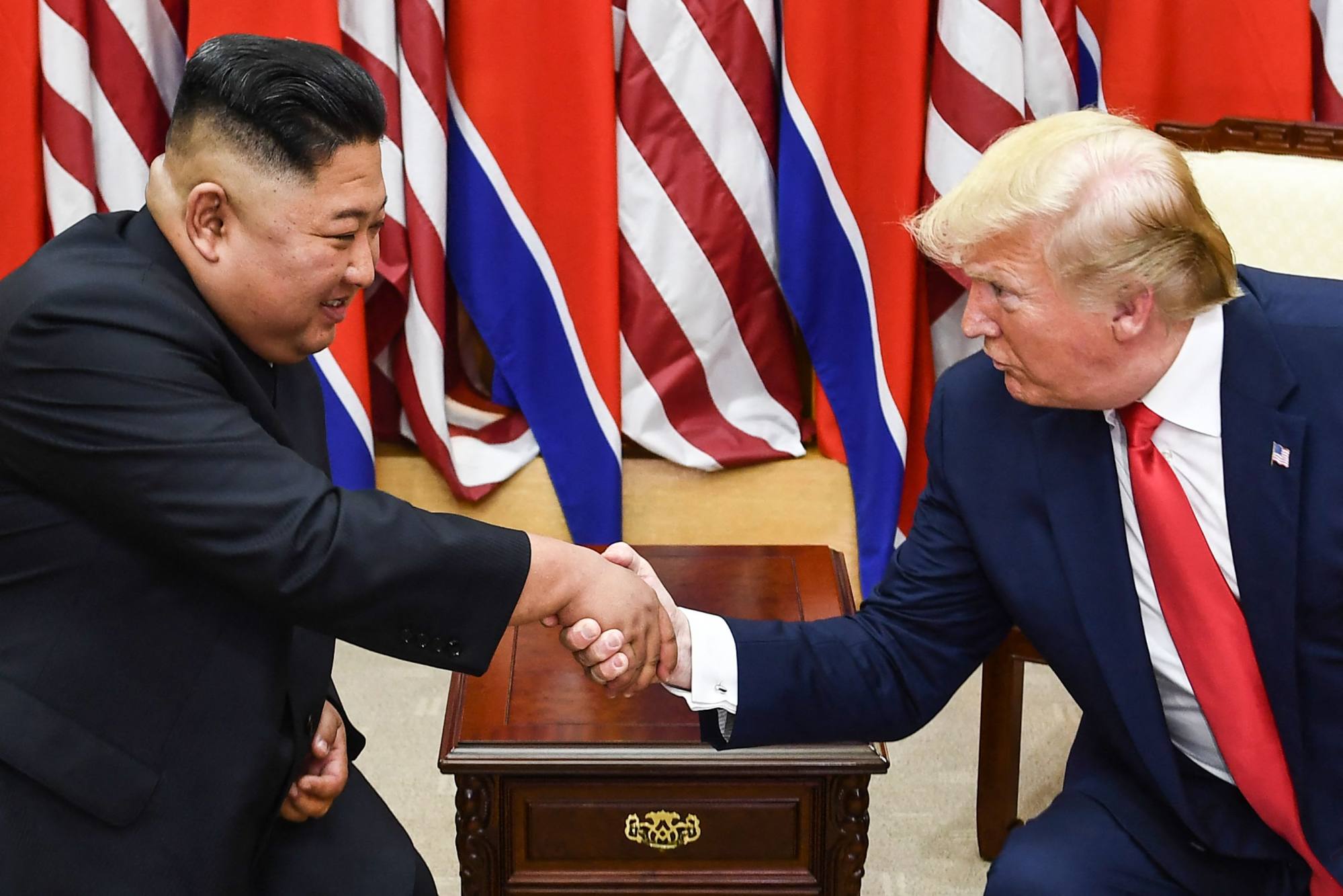 North Korea’s leader Kim Jong-un and US President Donald Trump shake hands during a meeting on the south side of the Military Demarcation Line that divides North and South Korea, on June 30, 2019. Photo: AFP