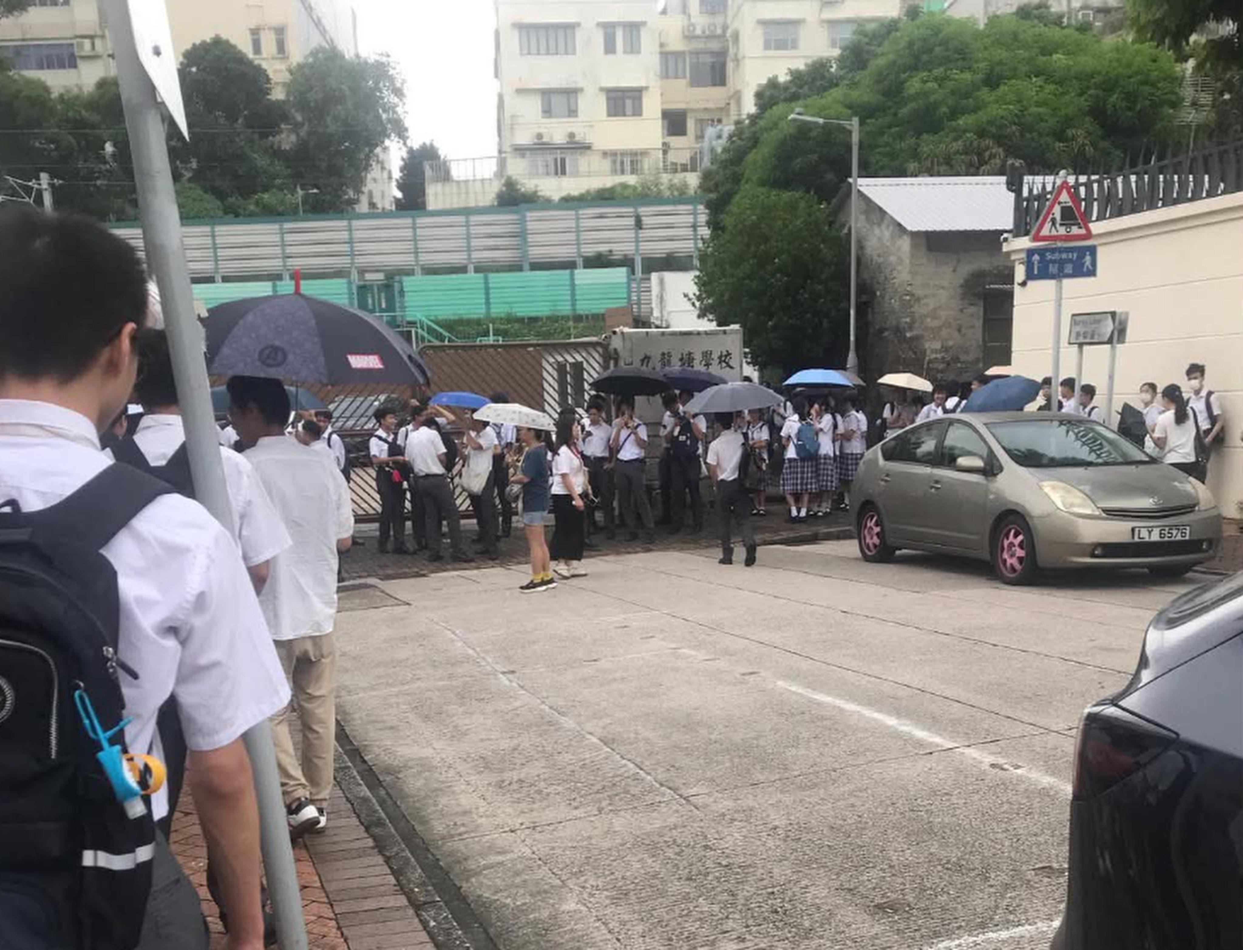 Students line up outside Kowloon Tong School (Secondary Section) for uniform and hair checks on Tuesday. Photo: Threads/chipmunk.5284928