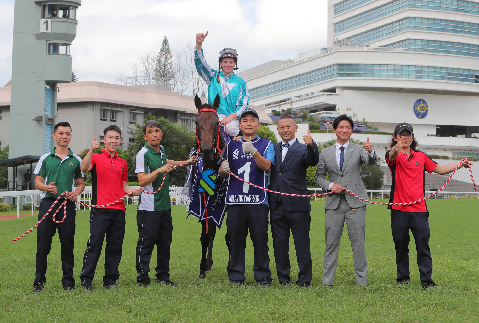Trainer Danny Shum (third from right) and stable staff celebrate Romantic Warrior’s most recent victory. Trainer Danny Shum (third from right) and stable staff celebrate Romantic Warrior’s most recent victory.
