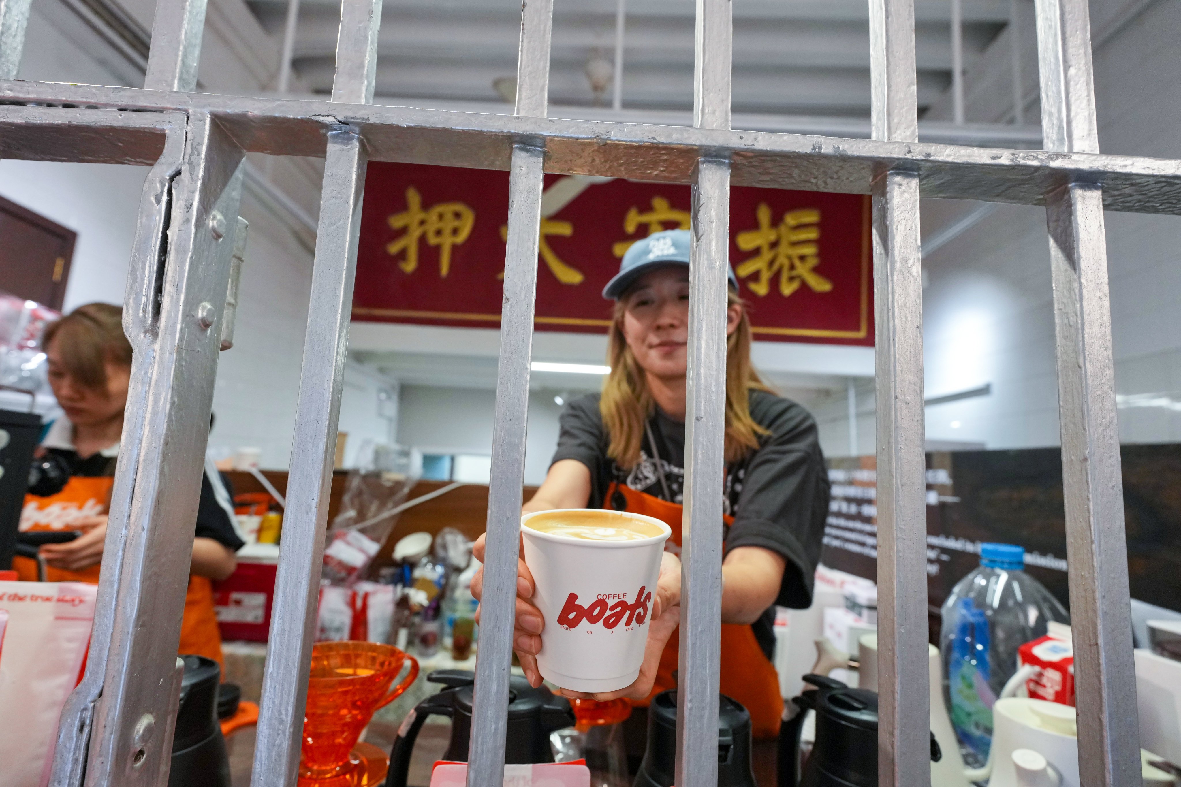 Visitors can enjoy a cup of coffee inside the pop-up community hub that was once a neighborhood lifeline for quick cash. Photo: Karma Lo