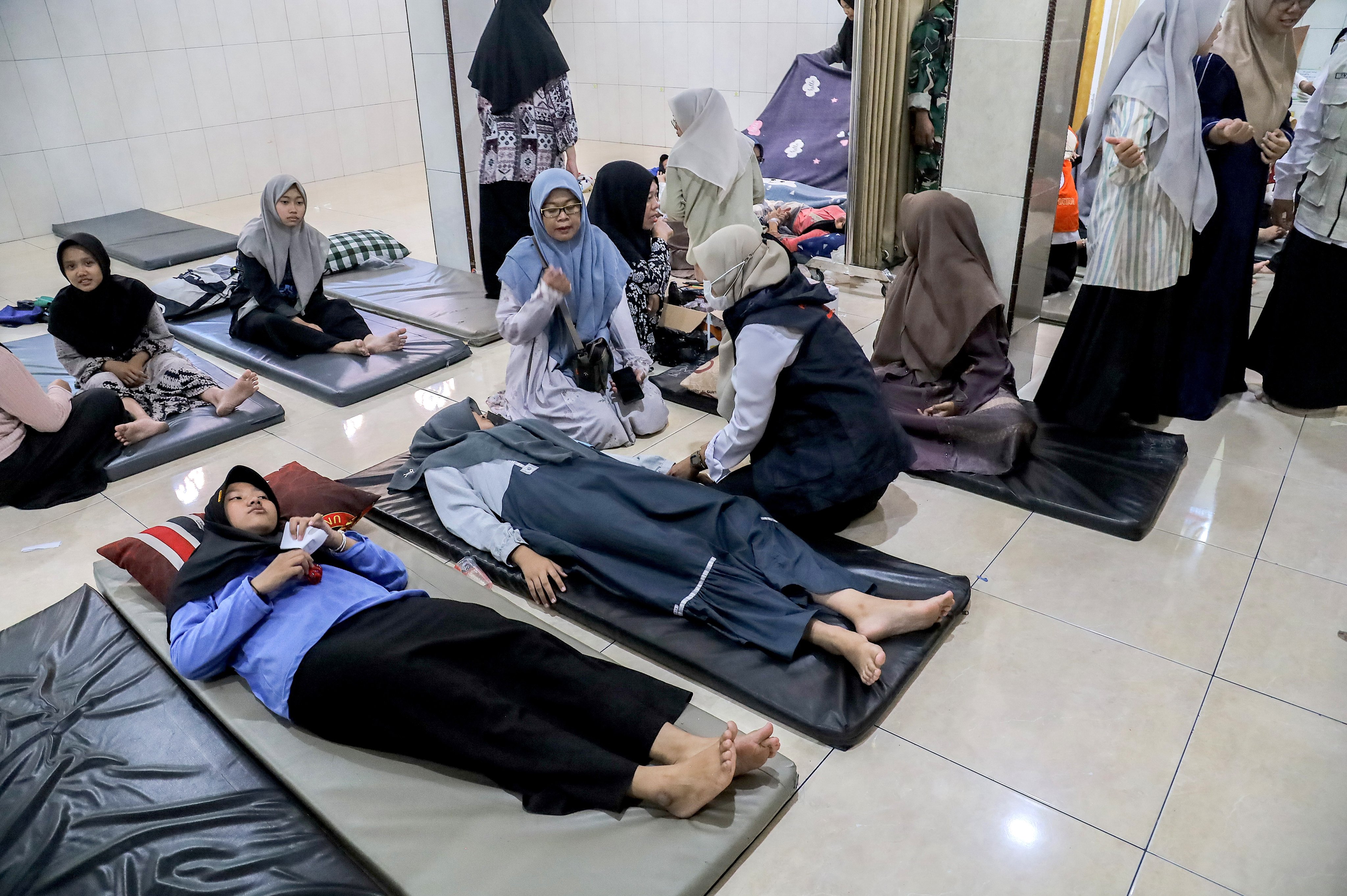 Students suffering from food poisoning receive treatment in Sidoarjo, East Java, Indonesia on Wednesday. Photo: EPA
