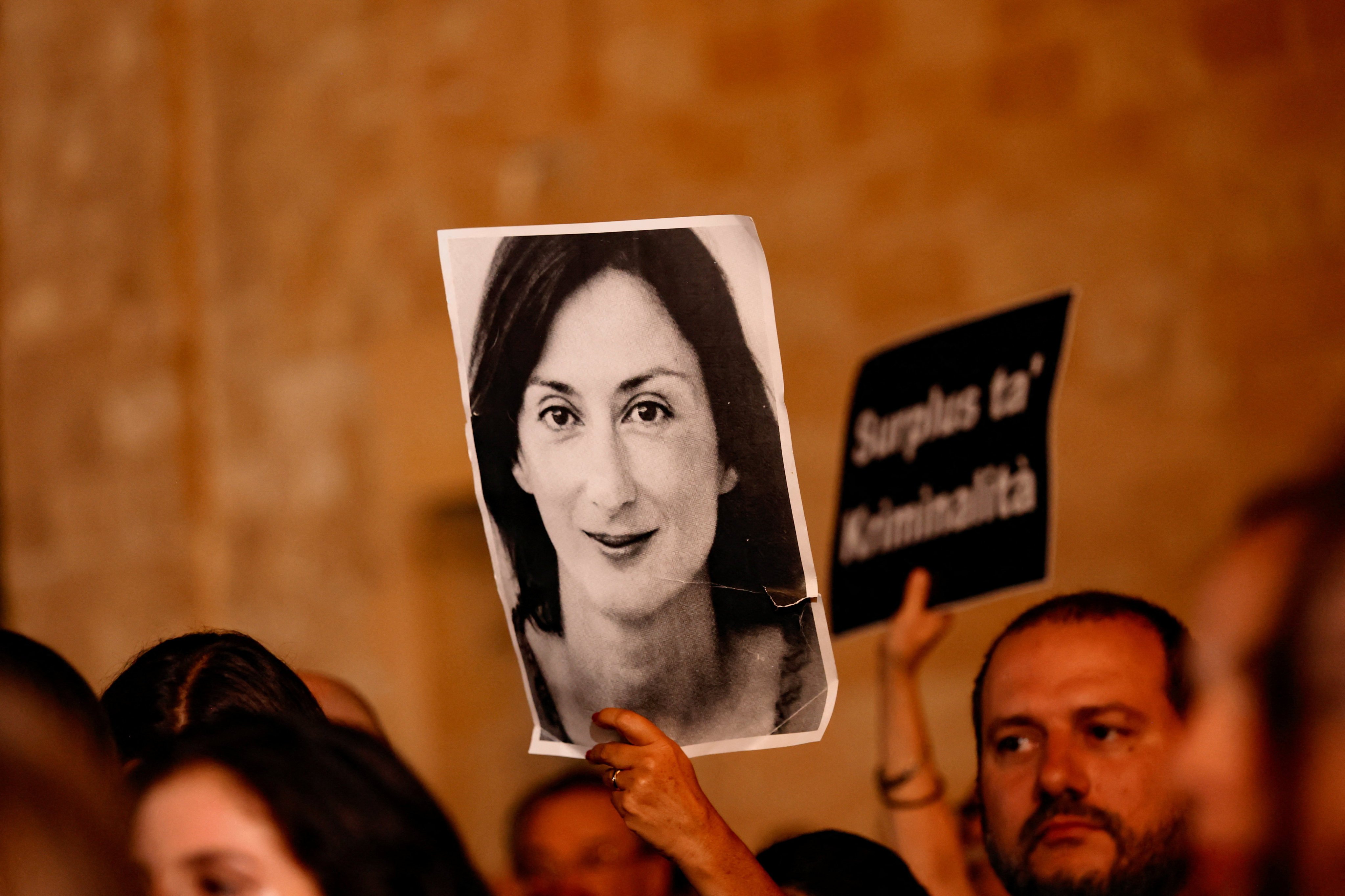 A portrait of investigative journalist Daphne Caruana Galizia is held up during a protest in Valletta, Malta, on Wednesday. Photo: Reuters